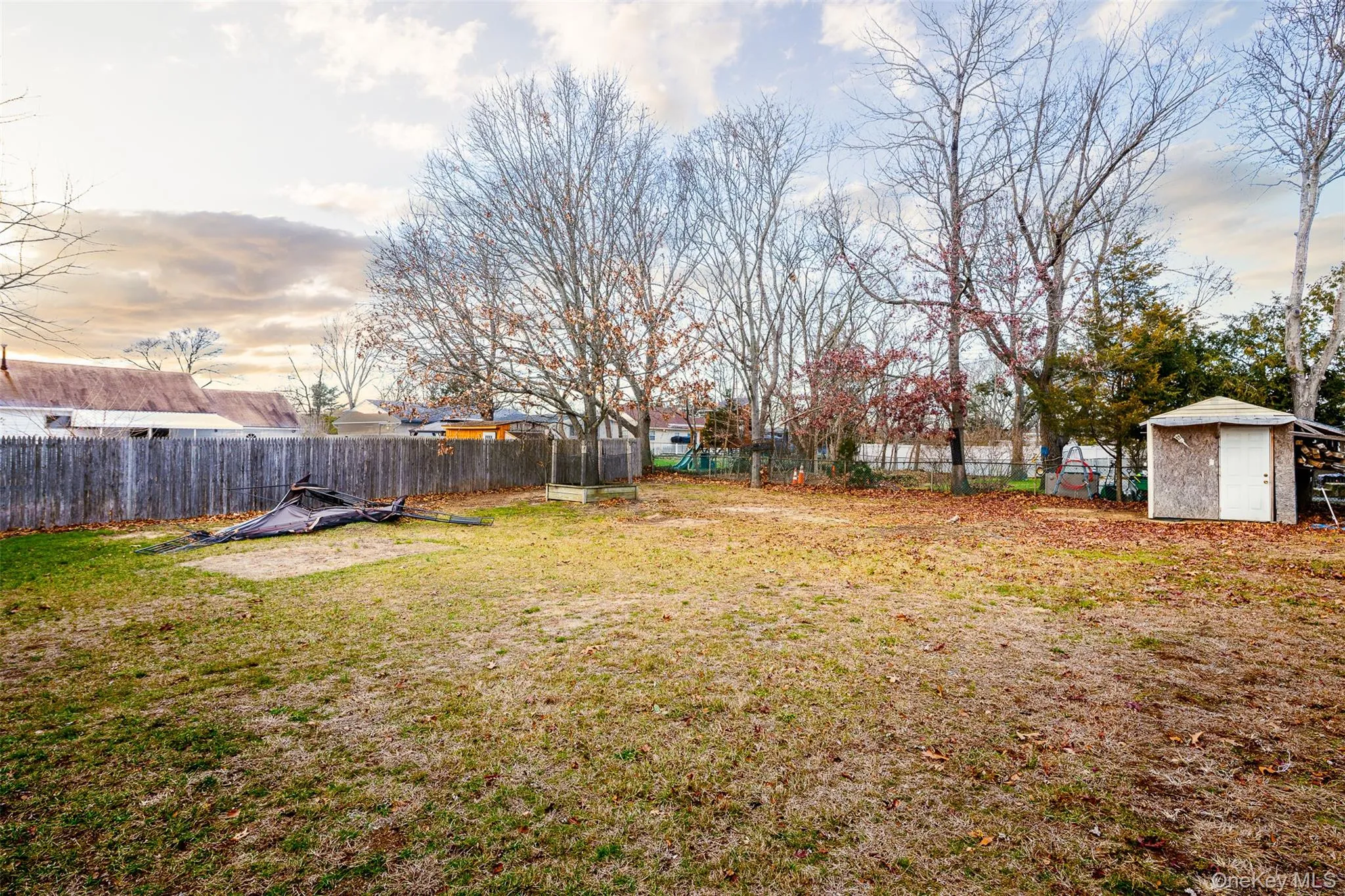 Fenced backyard with a storage unit Fenced backyard with a storage unit