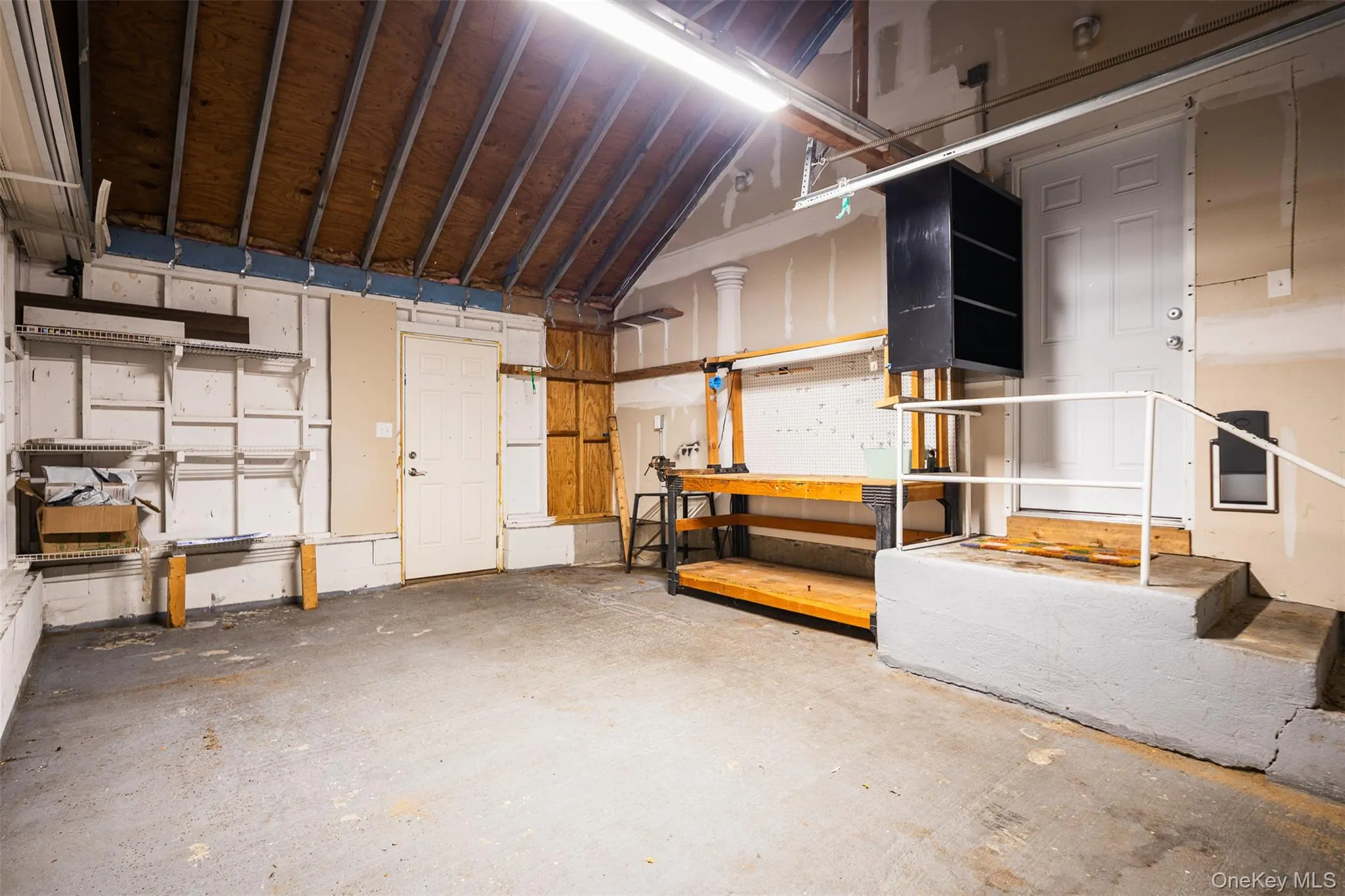 Garage featuring a workshop area Garage featuring a workshop area