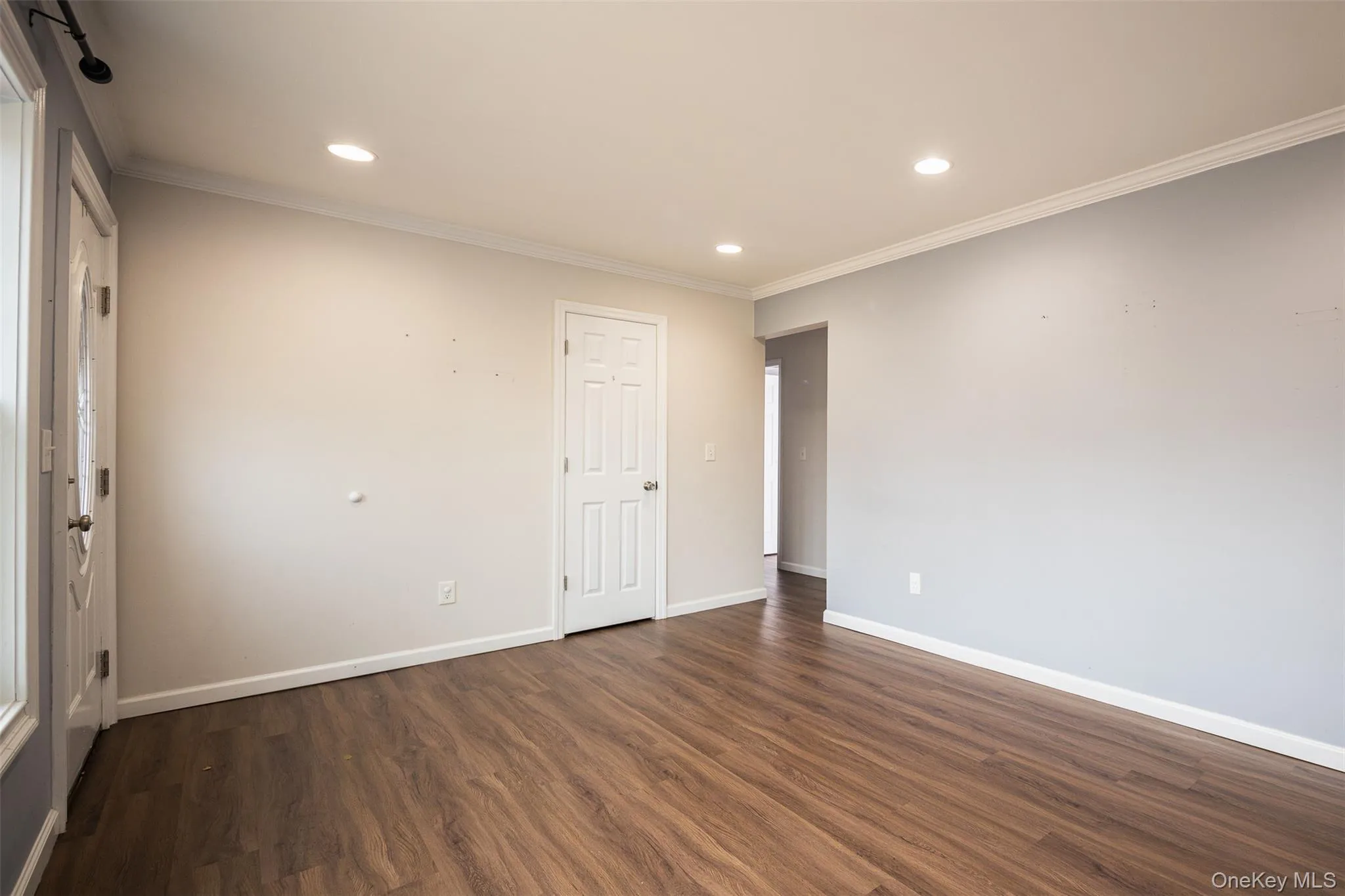 Unfurnished room featuring dark wood-type flooring, recessed lighting, and crown molding Unfurnished room featuring dark wood-type flooring, recessed lighting, and crown molding