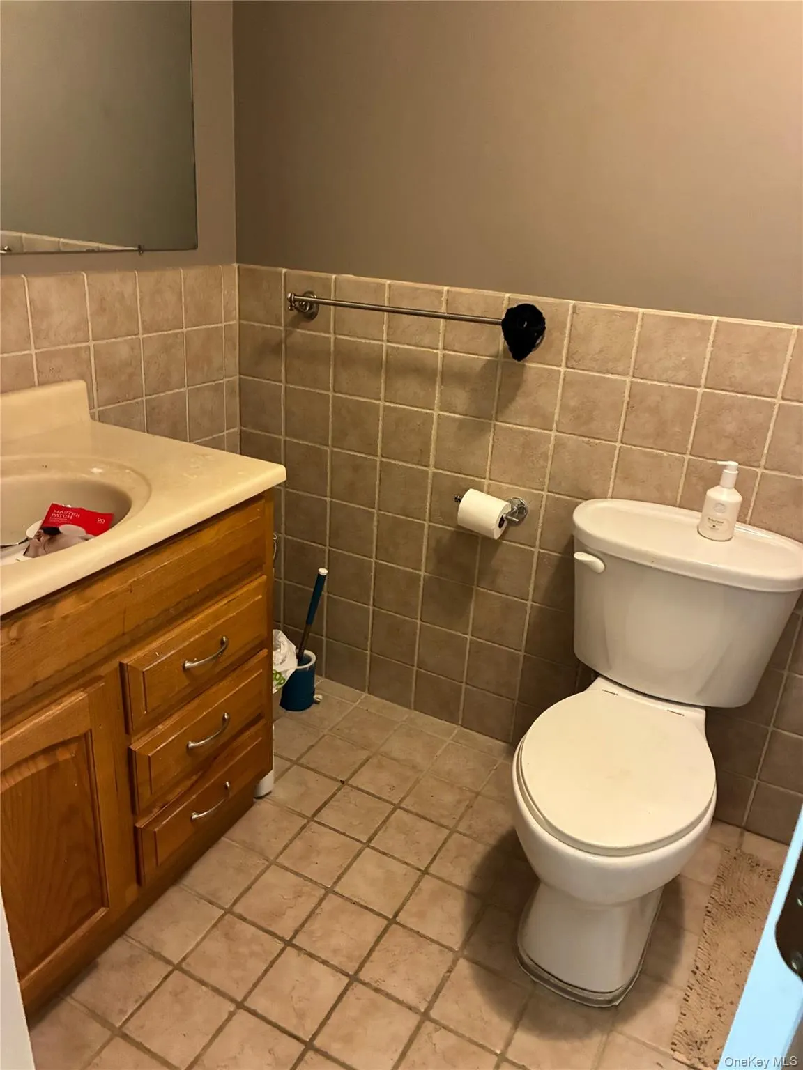 Bathroom with vanity, light tile patterned floors, tile wall Bathroom with vanity, light tile patterned floors, tile wall