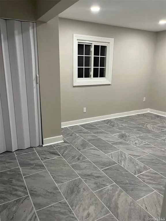 Unfurnished room with dark marble finish floors and recessed lighting Unfurnished room with dark marble finish floors and recessed lighting