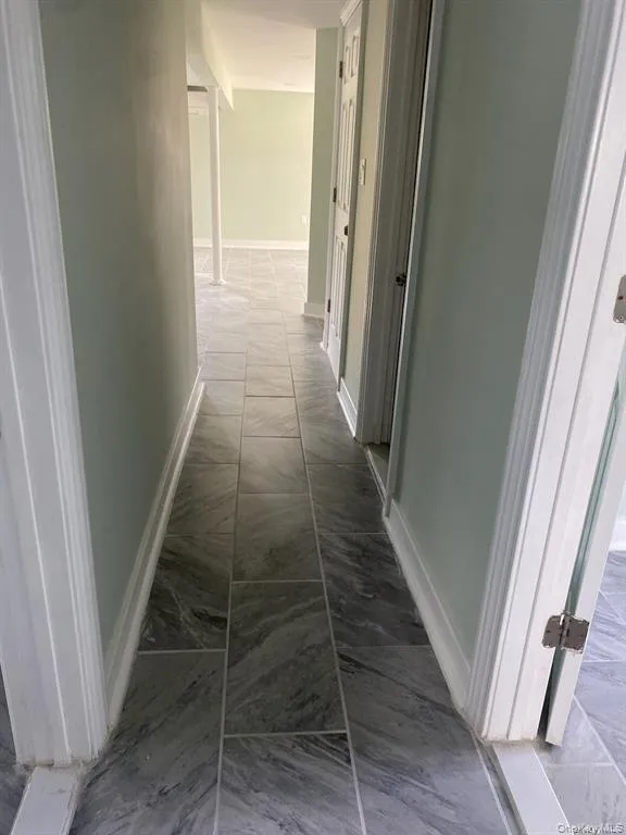 Hallway with light marble finish flooring Hallway with light marble finish flooring