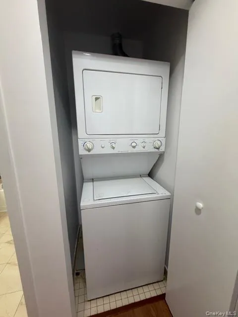 Washroom with stacked washing machine and dryer Washroom with stacked washing machine and dryer