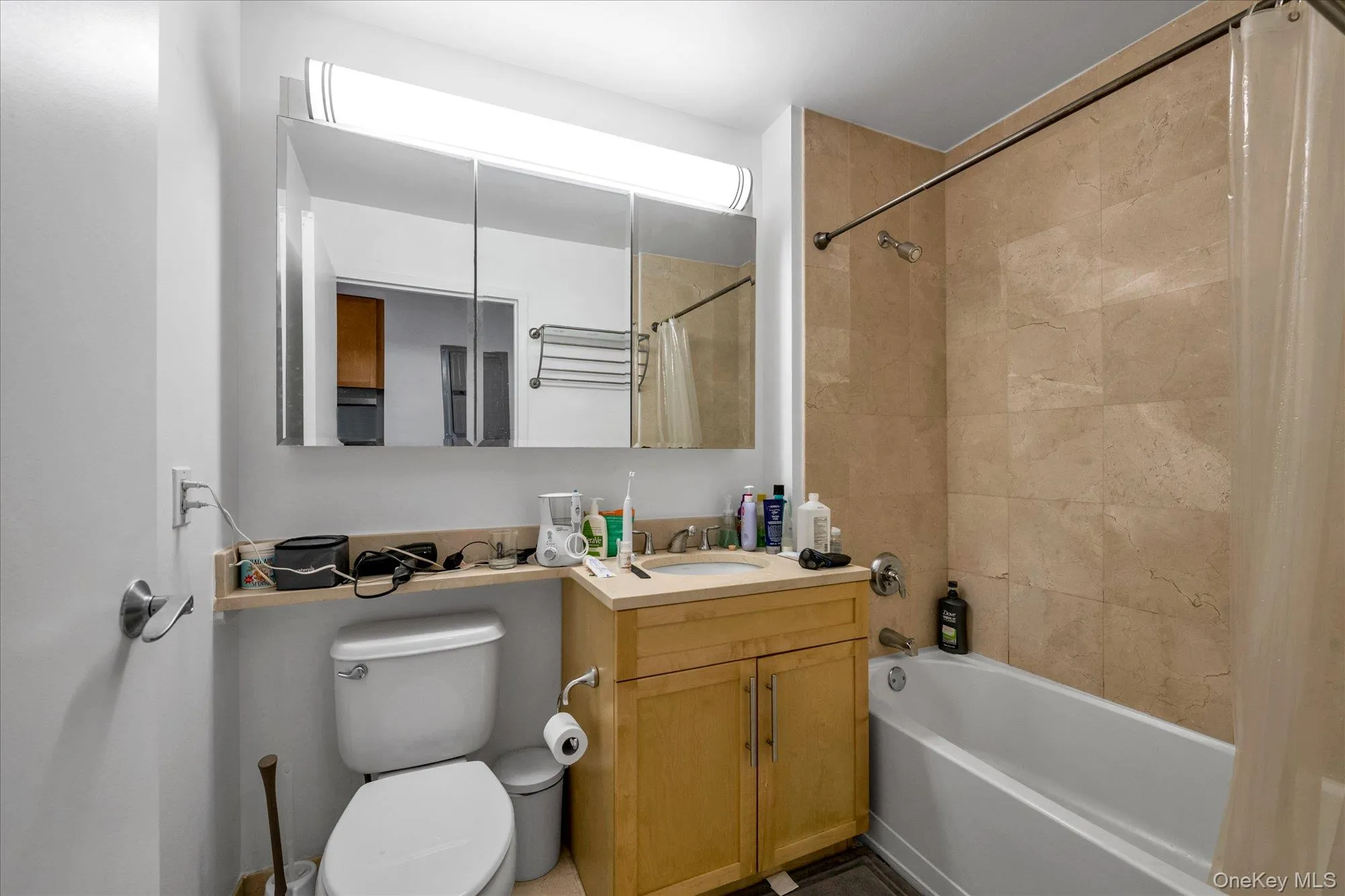 Full bathroom with shower / bath combination with curtain and vanity Full bathroom with shower / bath combination with curtain and vanity