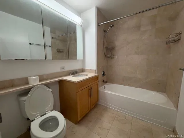 Full bath featuring vanity, shower / washtub combination, and light marble finish floors Full bath featuring vanity, shower / washtub combination, and light marble finish floors