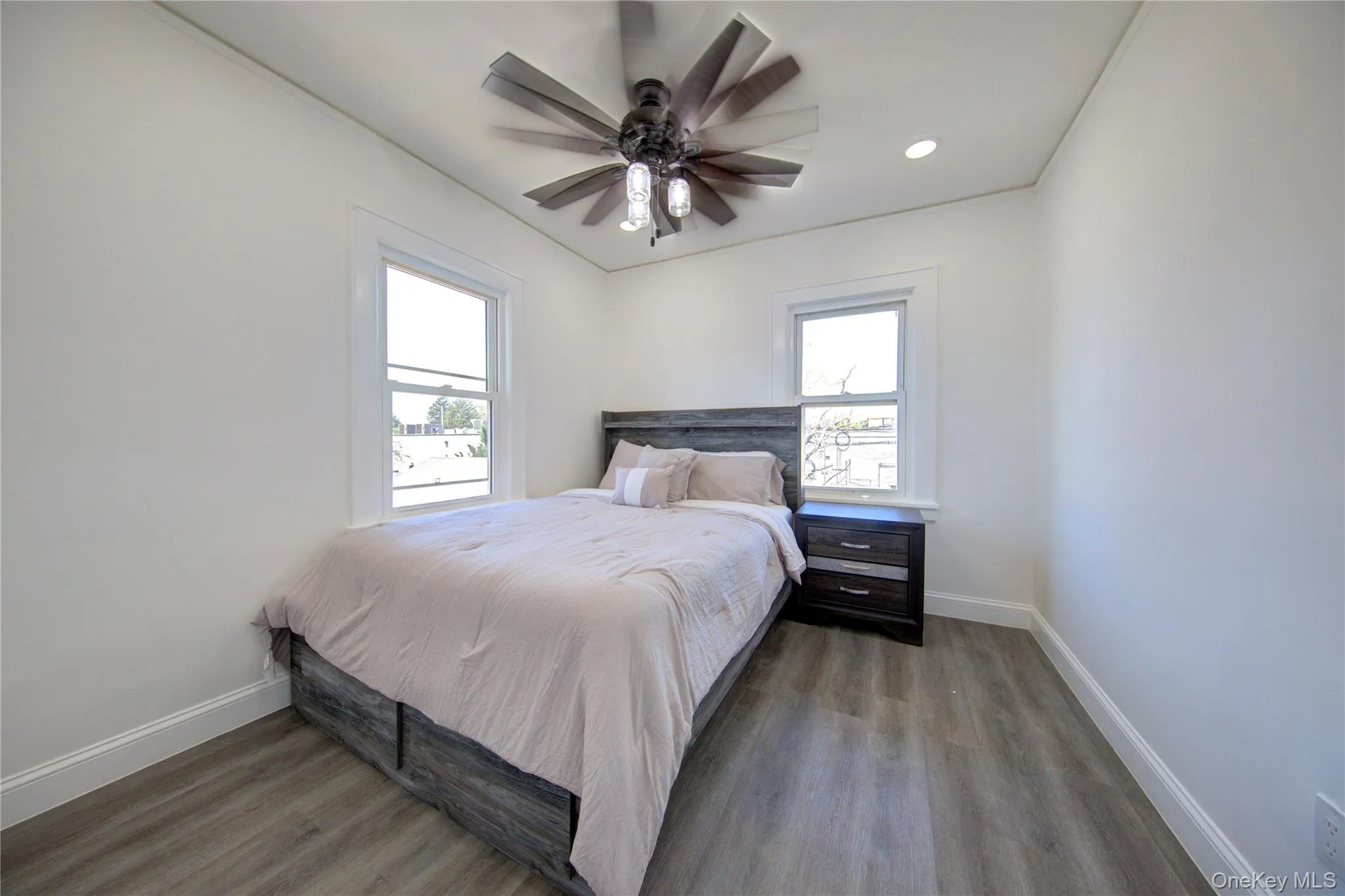Bedroom with dark wood-type flooring, ceiling fan, and recessed lighting Bedroom with dark wood-type flooring, ceiling fan, and recessed lighting