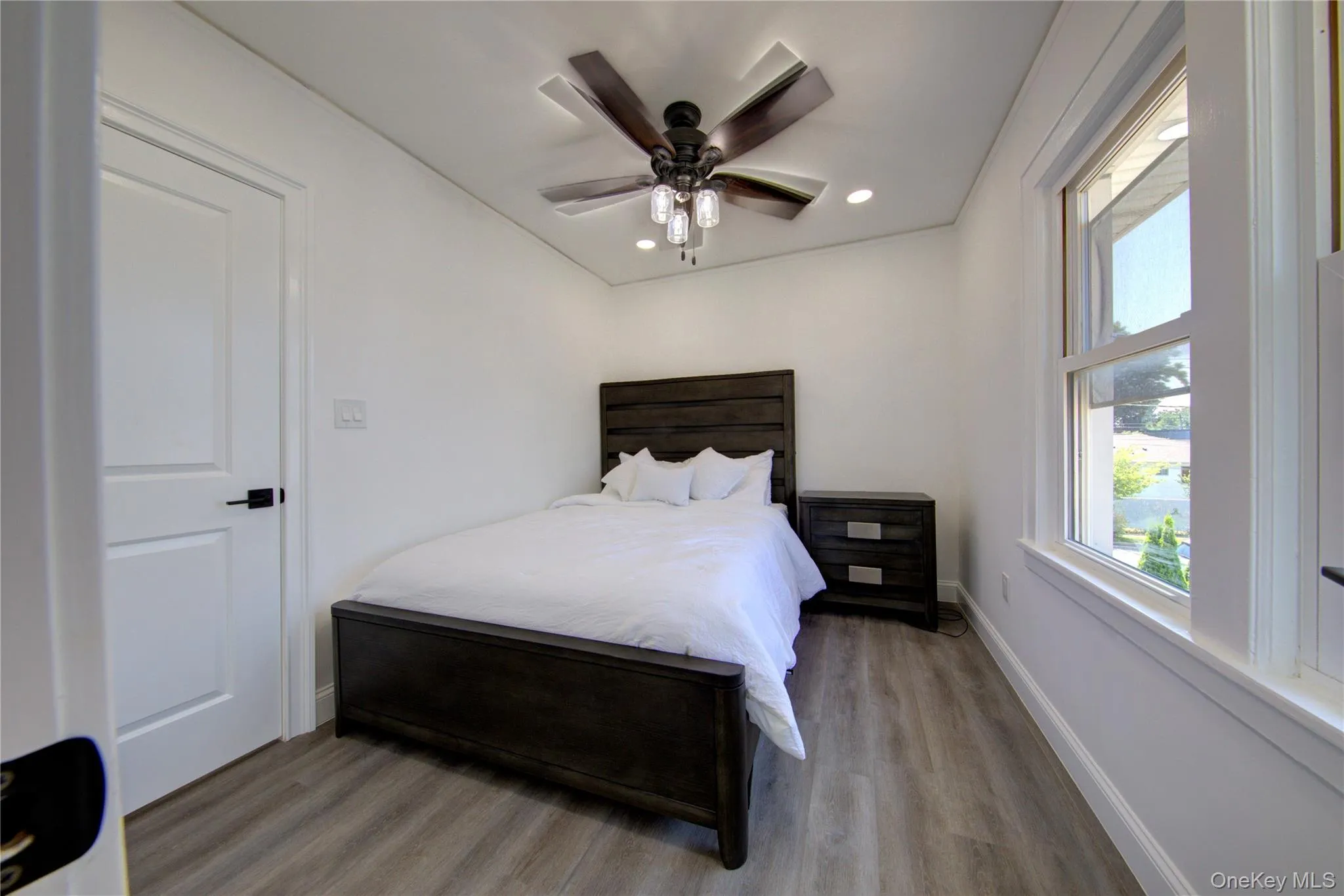 Bedroom with wood finished floors, a ceiling fan, and recessed lighting Bedroom with wood finished floors, a ceiling fan, and recessed lighting