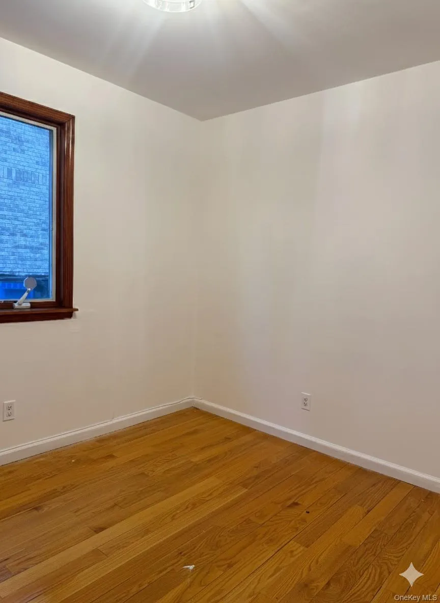 Empty room with light wood-type flooring and baseboards Empty room with light wood-type flooring and baseboards