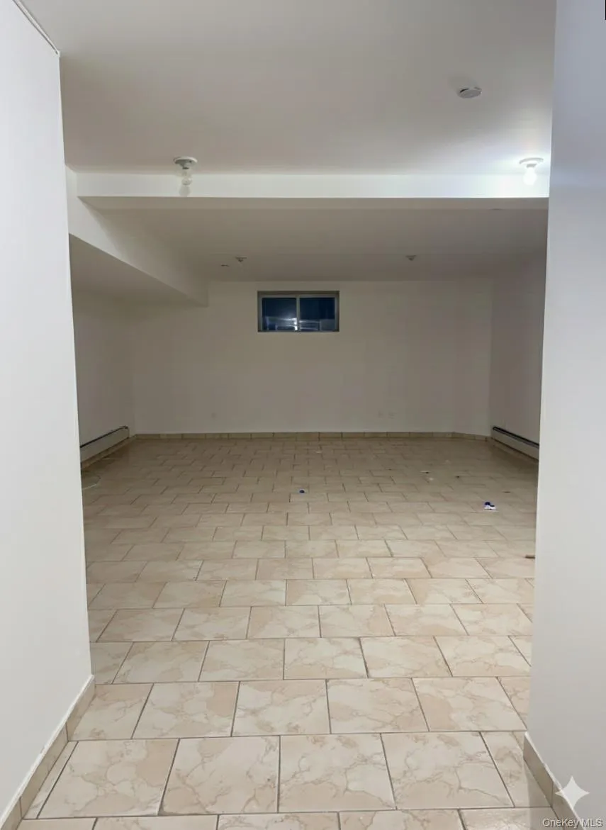 Unfurnished room featuring a baseboard heating unit Unfurnished room featuring a baseboard heating unit