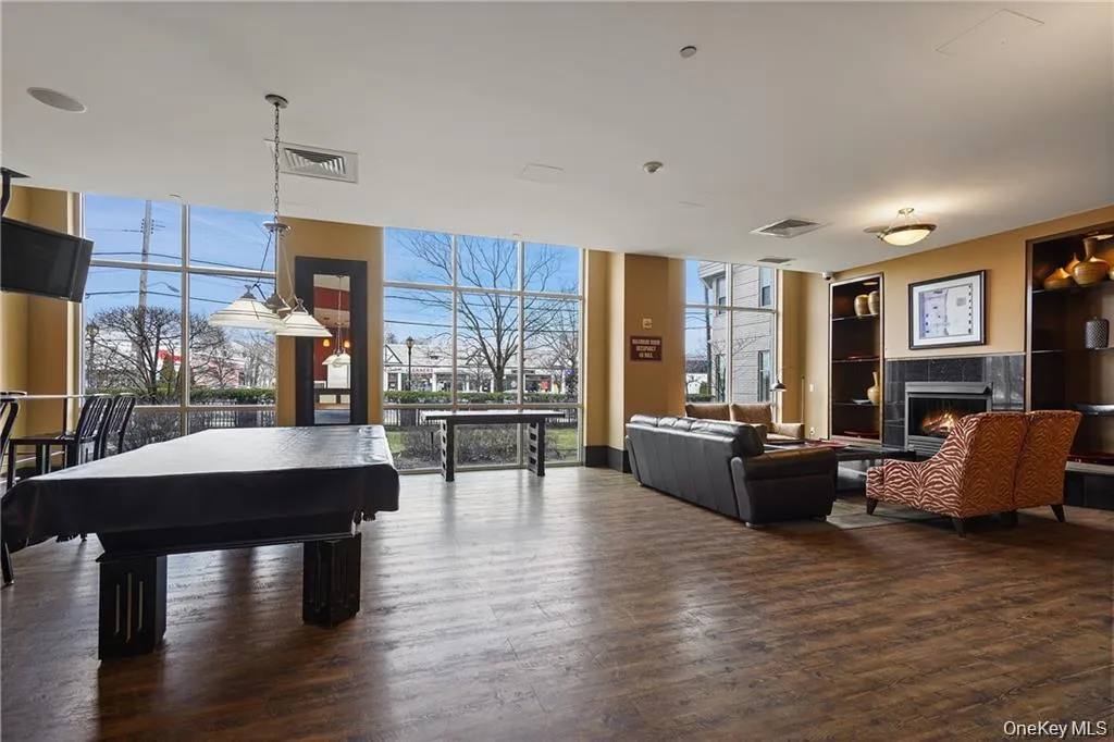 Social room featuring a pool table and fireplace Social room featuring a pool table and fireplace