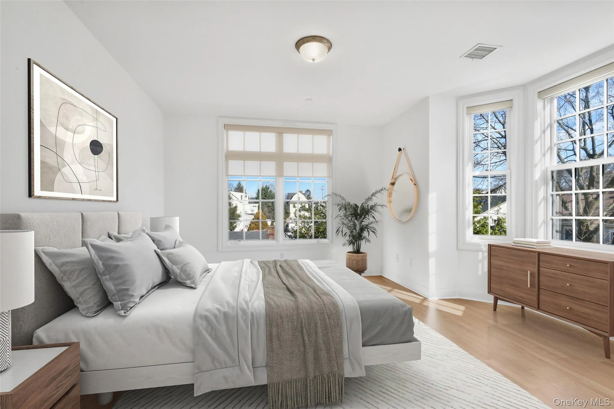 Bedroom featuring light wood finished floors and baseboards Bedroom featuring light wood finished floors and baseboards