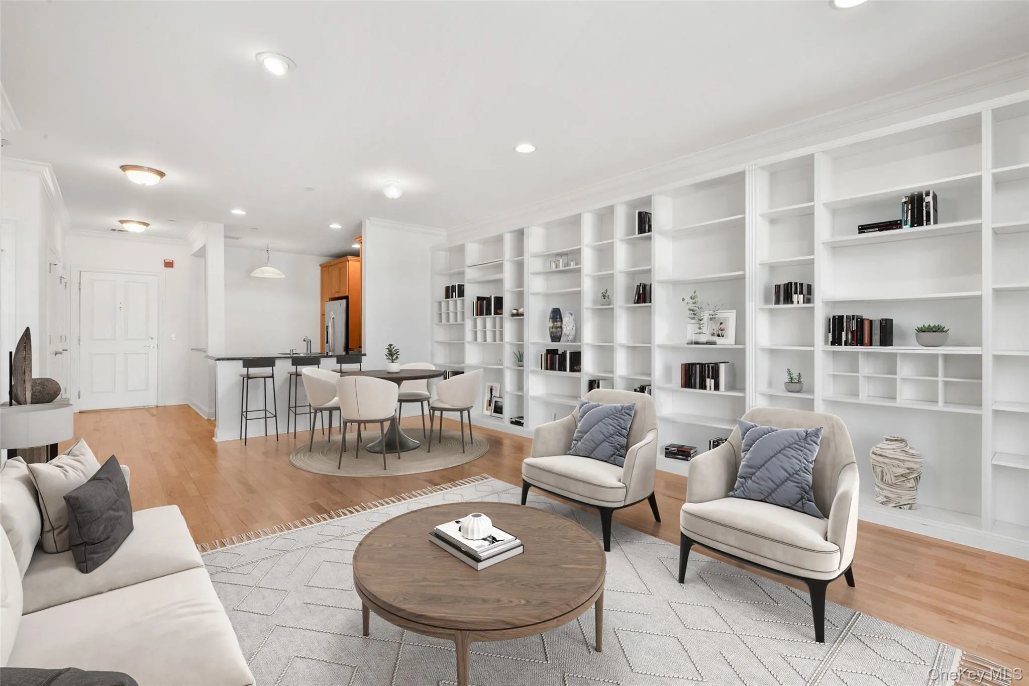 Living room with light wood-style floors, recessed lighting, and crown molding Living room with light wood-style floors, recessed lighting, and crown molding