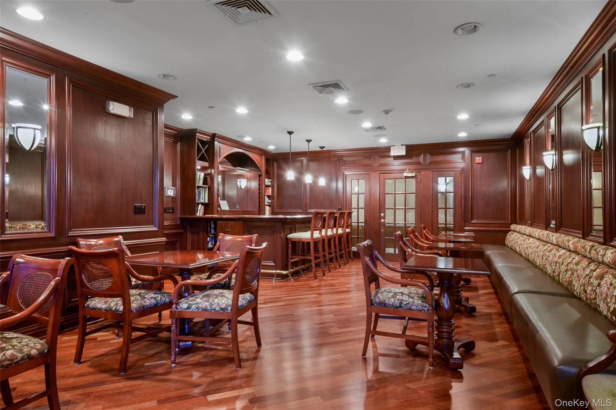 Dining room with light wood-style floors, crown molding, recessed lighting, and a decorative wall Dining room with light wood-style floors, crown molding, recessed lighting, and a decorative wall