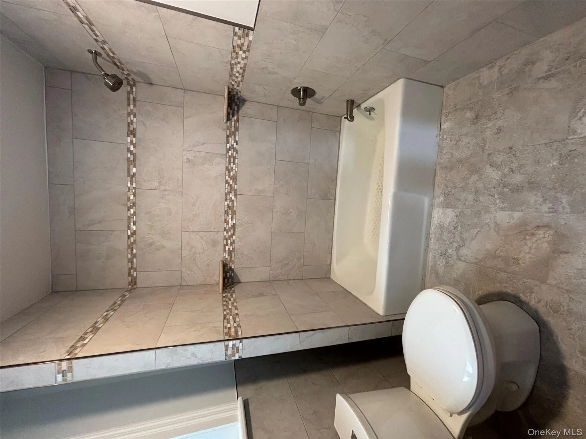 Full bath with shower / bathtub combination and tile walls Full bath with shower / bathtub combination and tile walls