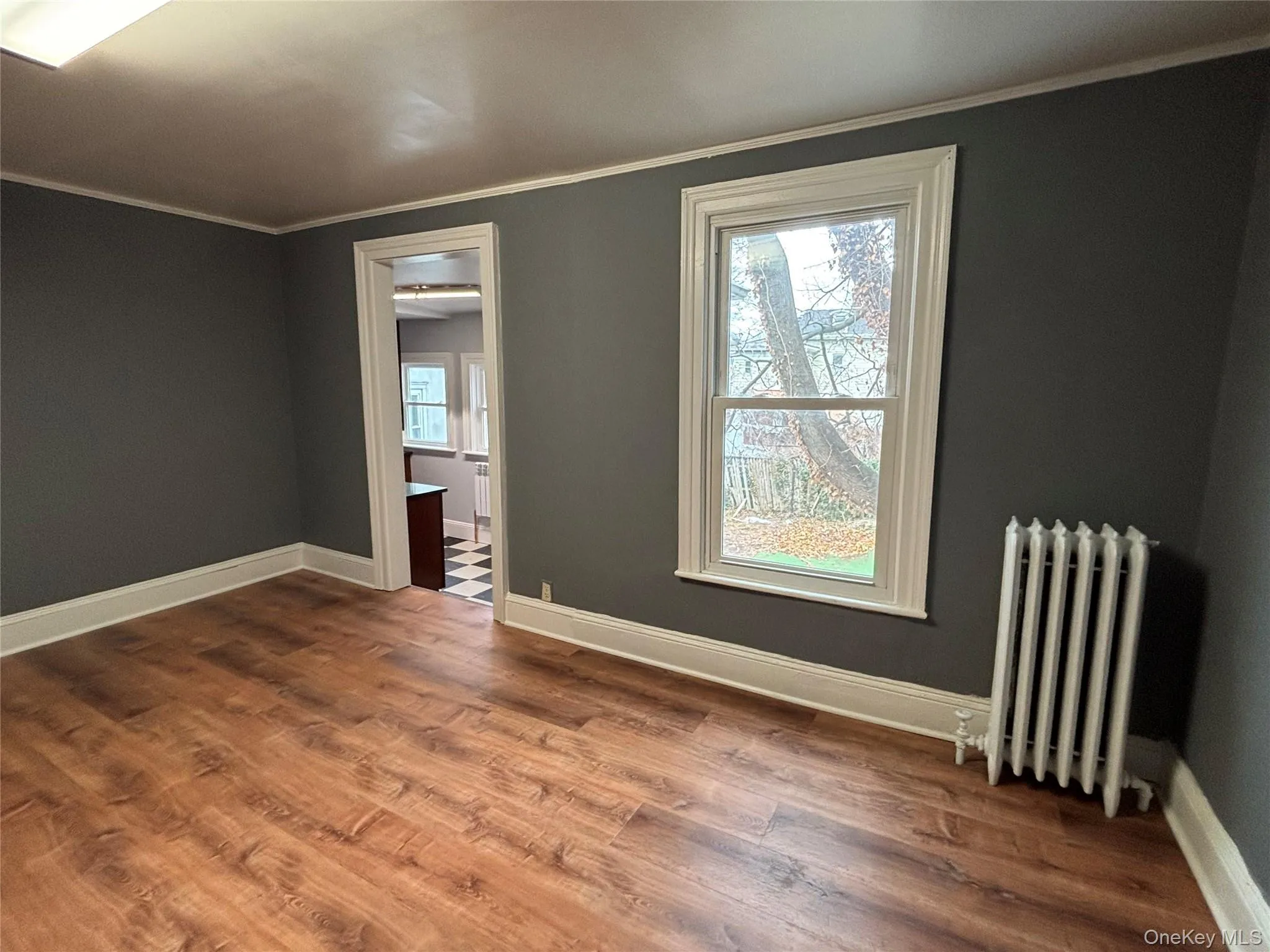 All freshly painted ornamental molding, plenty of natural light, and dark wood-type flooring All freshly painted ornamental molding, plenty of natural light, and dark wood-type flooring