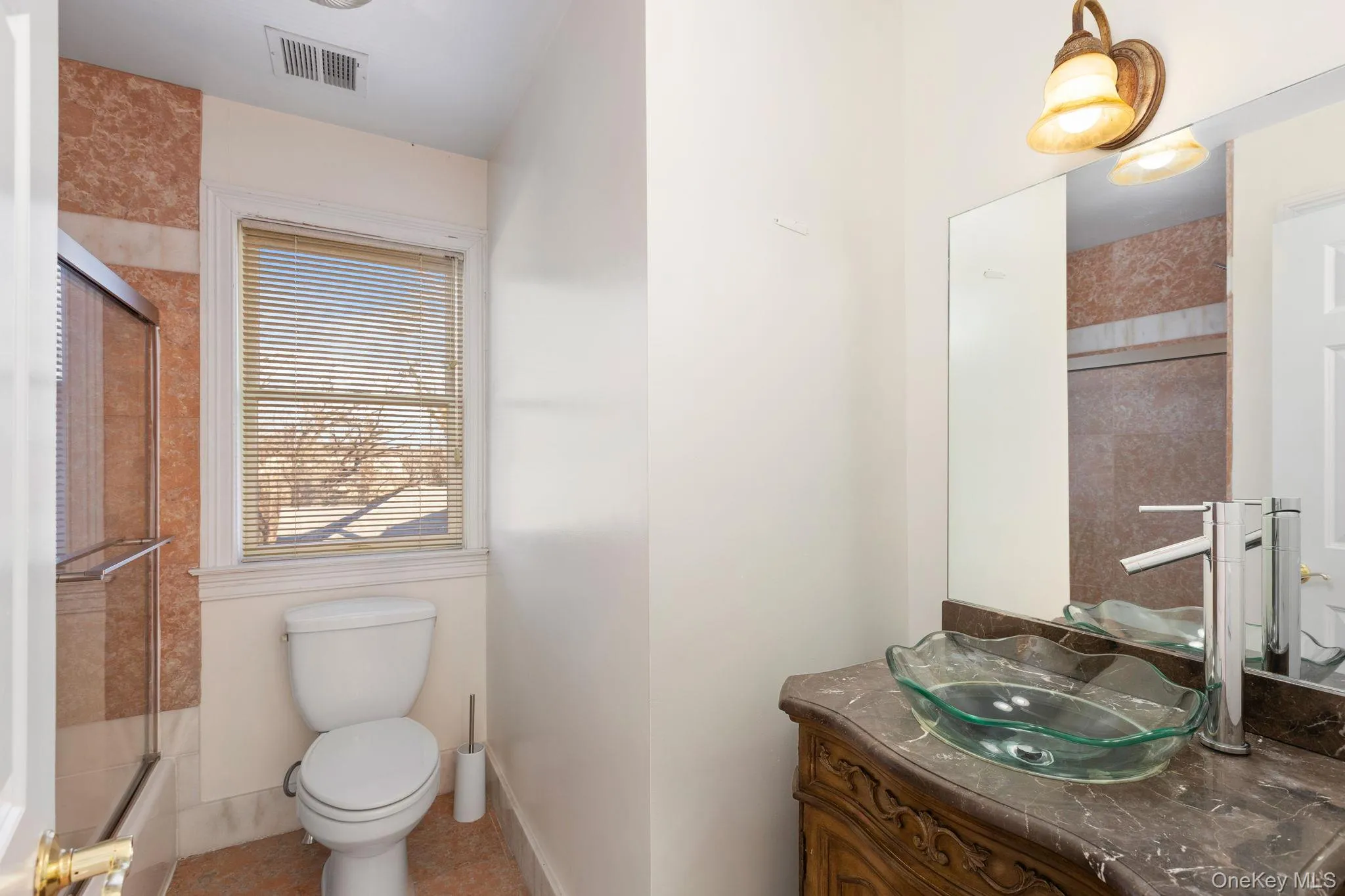 Full bath featuring vanity and a shower with door Full bath featuring vanity and a shower with door