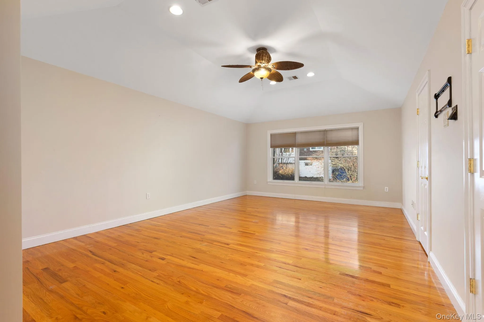 Unfurnished living room with recessed lighting, a ceiling fan, light wood finished floors, and lofted ceiling Unfurnished living room with recessed lighting, a ceiling fan, light wood finished floors, and lofted ceiling