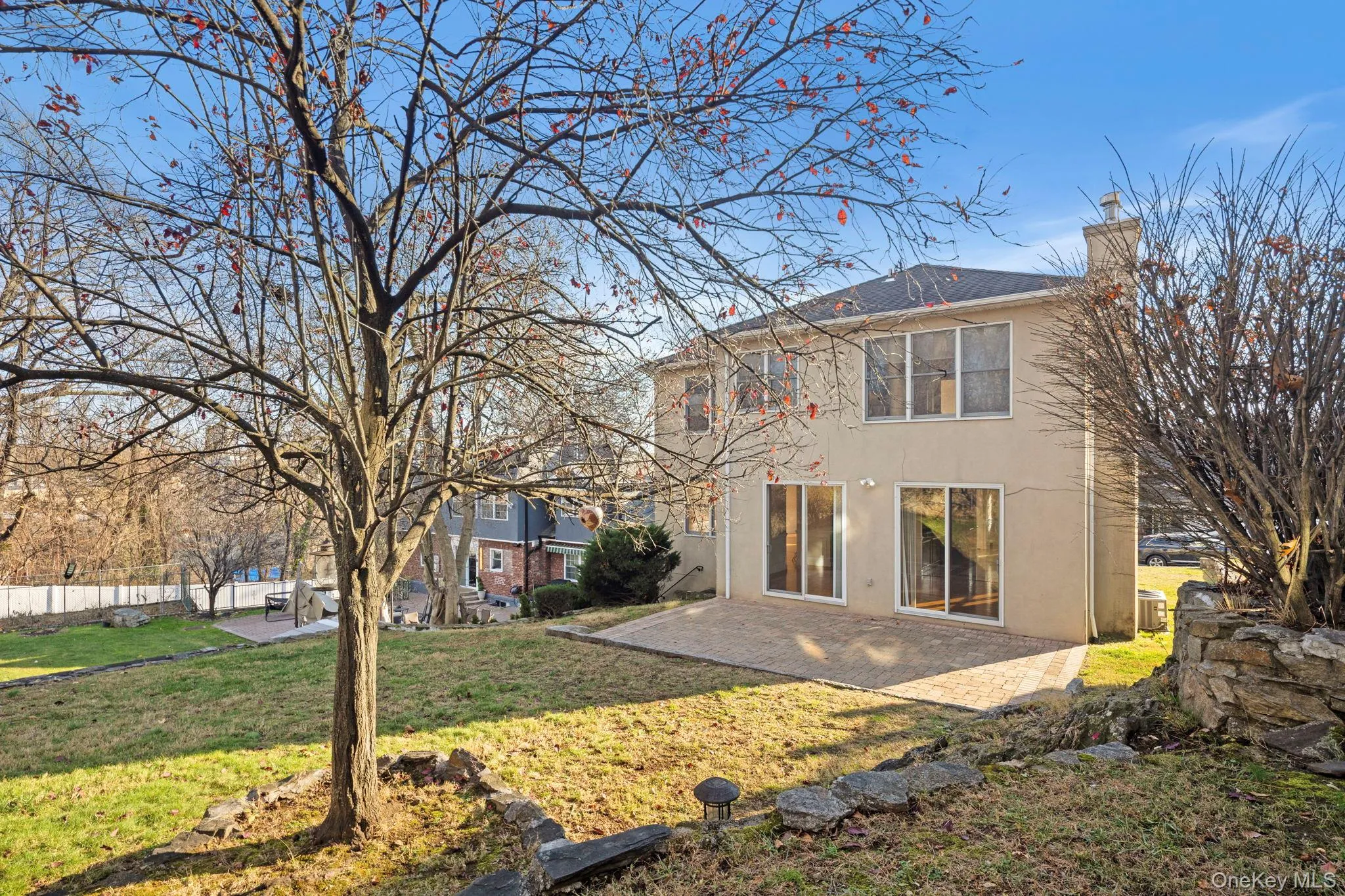 Back of property with a patio area, a chimney, and stucco siding Back of property with a patio area, a chimney, and stucco siding