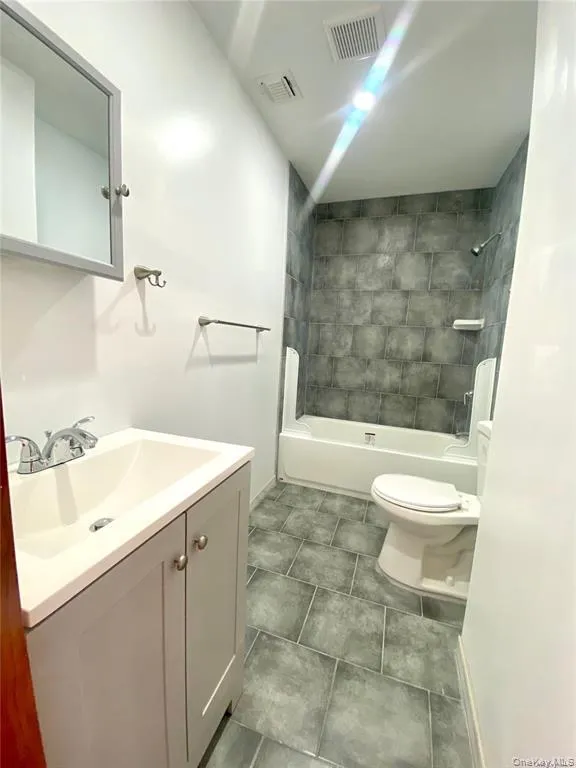 Full bath with vanity, shower / bath combination, and tile patterned flooring Full bath with vanity, shower / bath combination, and tile patterned flooring