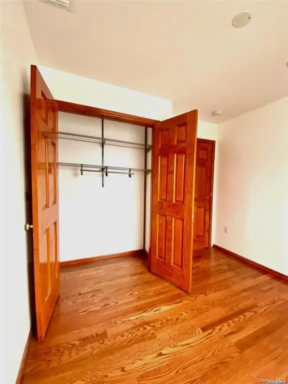Unfurnished bedroom featuring a closet and light wood-style floors Unfurnished bedroom featuring a closet and light wood-style floors