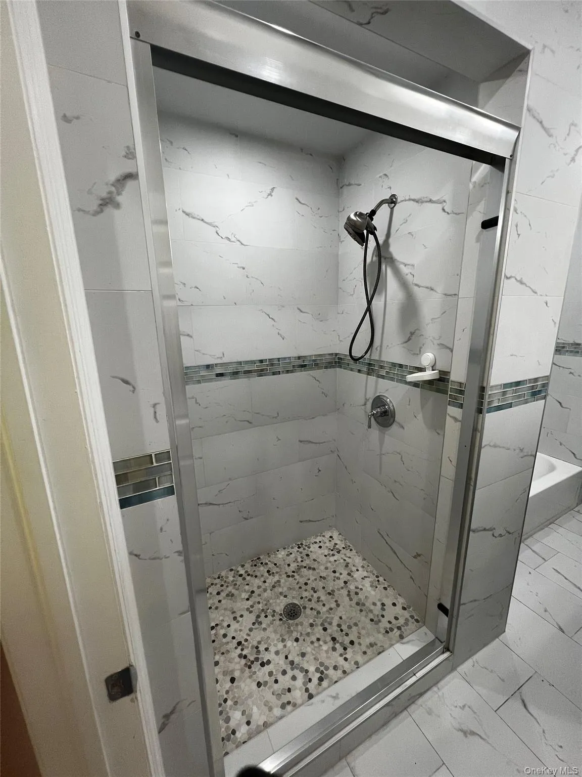 Full bath with marble finish flooring and a marble finish shower Full bath with marble finish flooring and a marble finish shower