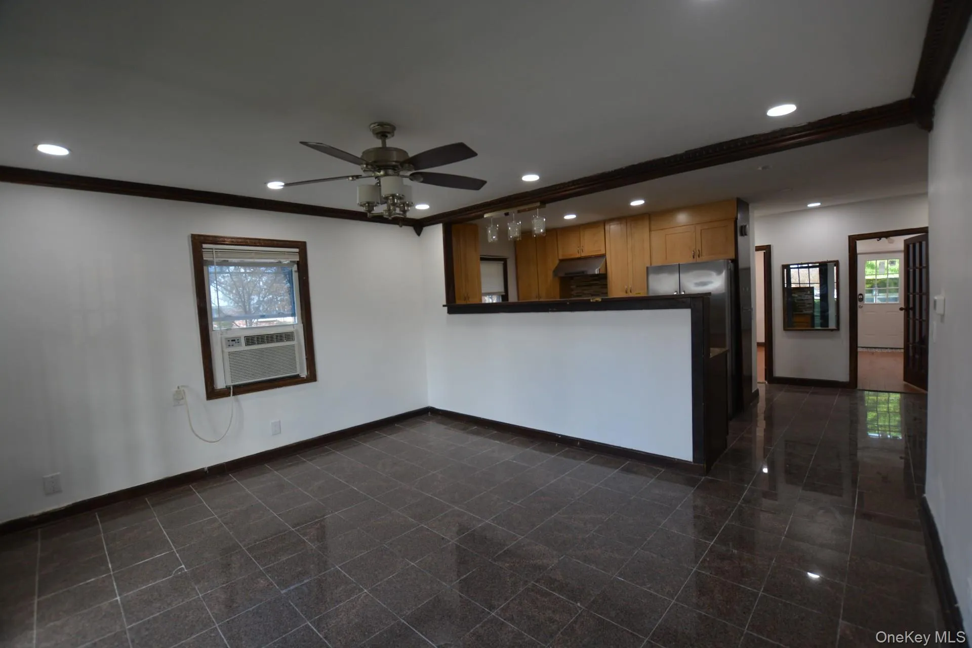 Unfurnished living room featuring recessed lighting, crown molding, a ceiling fan, and cooling unit Unfurnished living room featuring recessed lighting, crown molding, a ceiling fan, and cooling unit