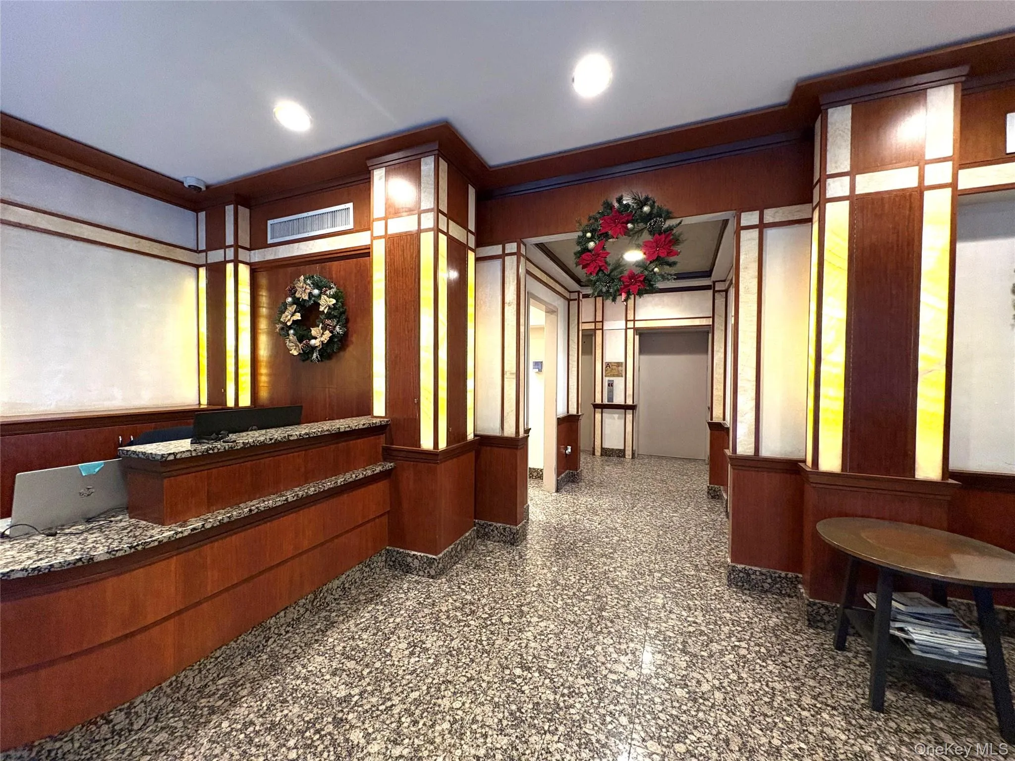 Reception with wooden walls, ornamental molding, and recessed lighting Reception with wooden walls, ornamental molding, and recessed lighting