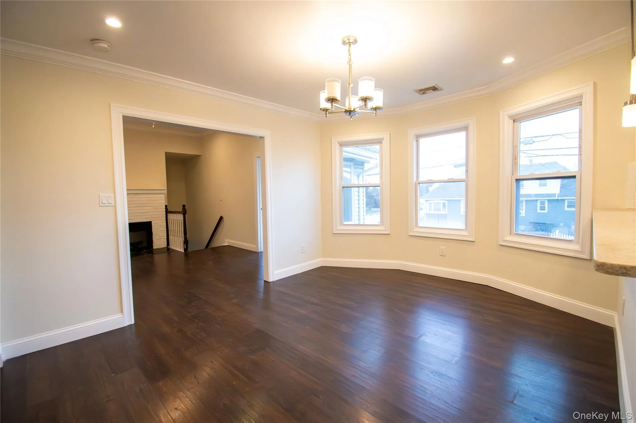 Unfurnished dining area with crown molding, dark wood-style floors, recessed lighting, and a chandelier Unfurnished dining area with crown molding, dark wood-style floors, recessed lighting, and a chandelier