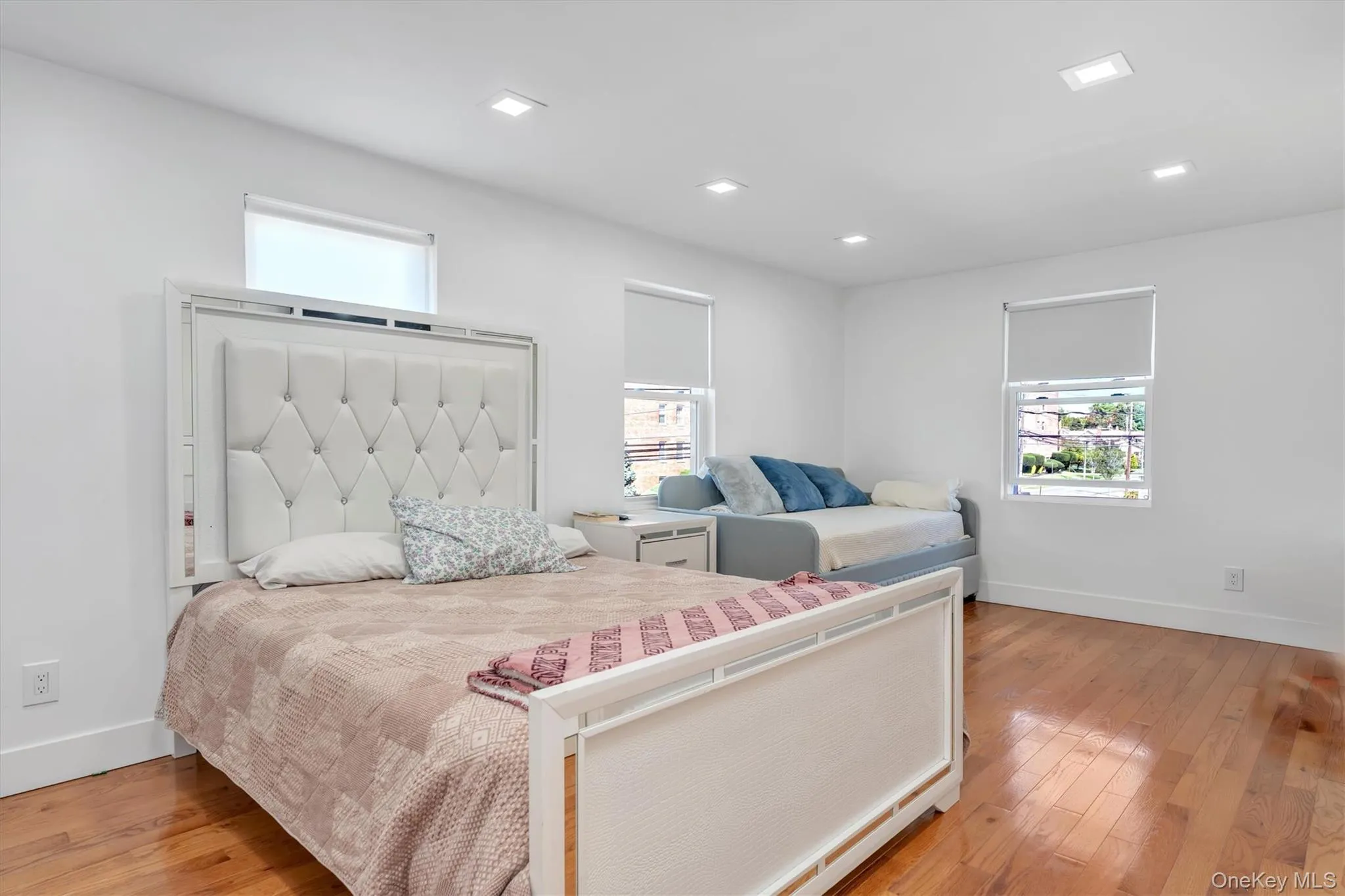Bedroom with light wood-style flooring and recessed lighting Bedroom with light wood-style flooring and recessed lighting