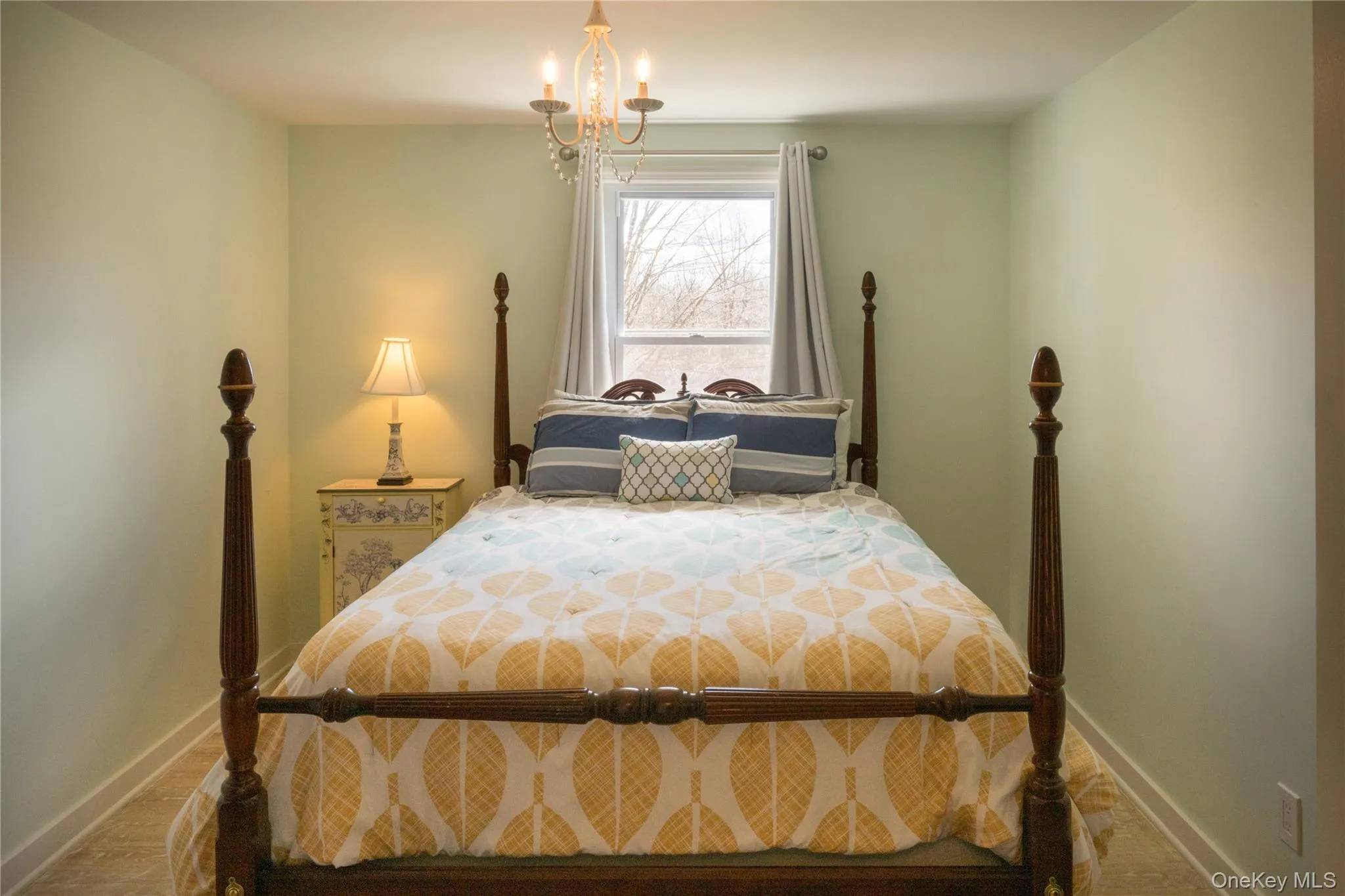 Bedroom featuring baseboards and a chandelier Bedroom featuring baseboards and a chandelier