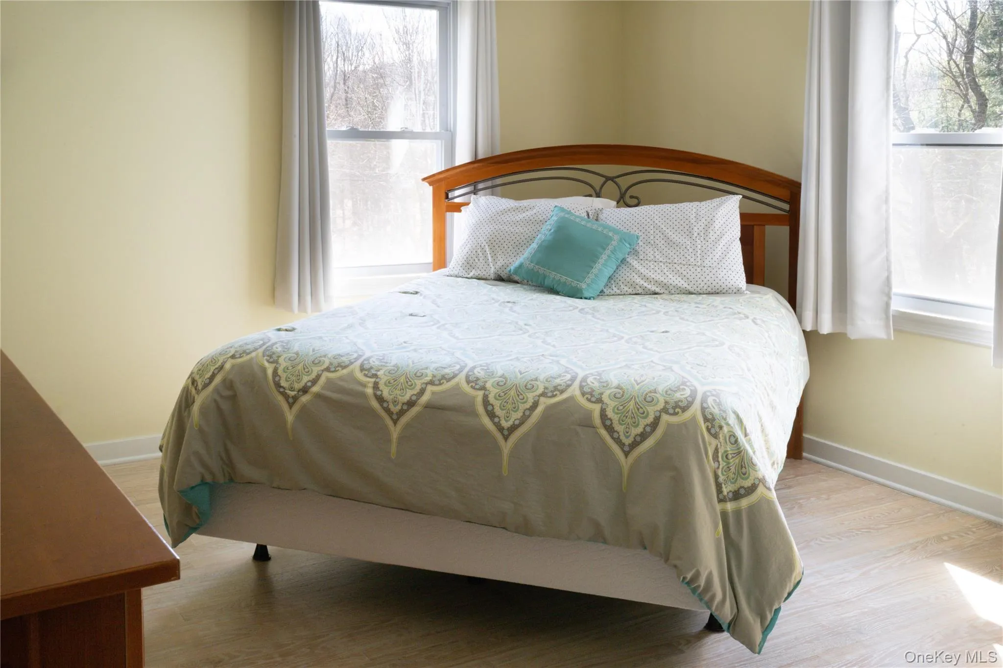 Bedroom featuring baseboards and light wood-style floors Bedroom featuring baseboards and light wood-style floors
