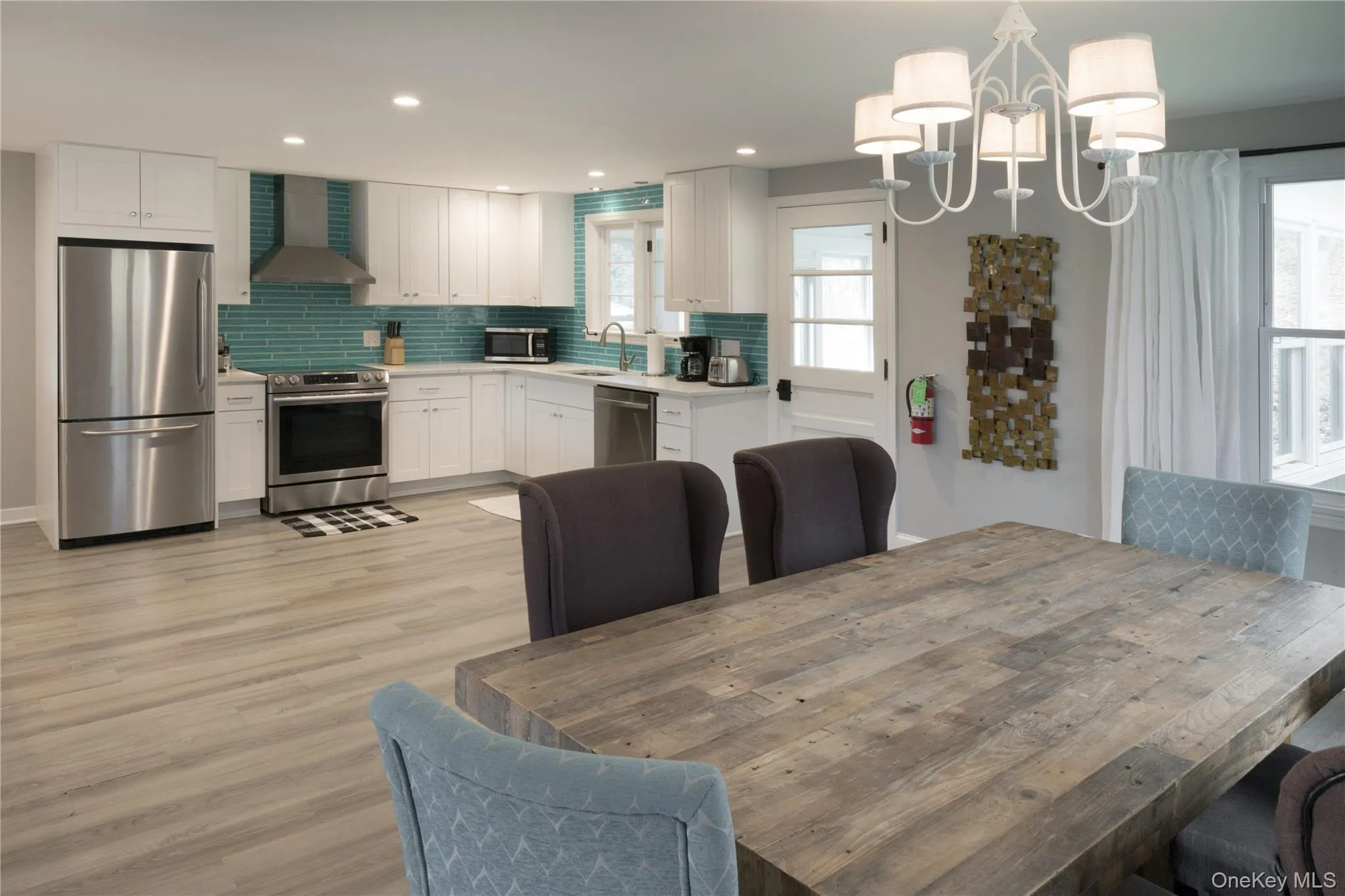 Dining space featuring a chandelier, light wood-style floors, and recessed lighting Dining space featuring a chandelier, light wood-style floors, and recessed lighting
