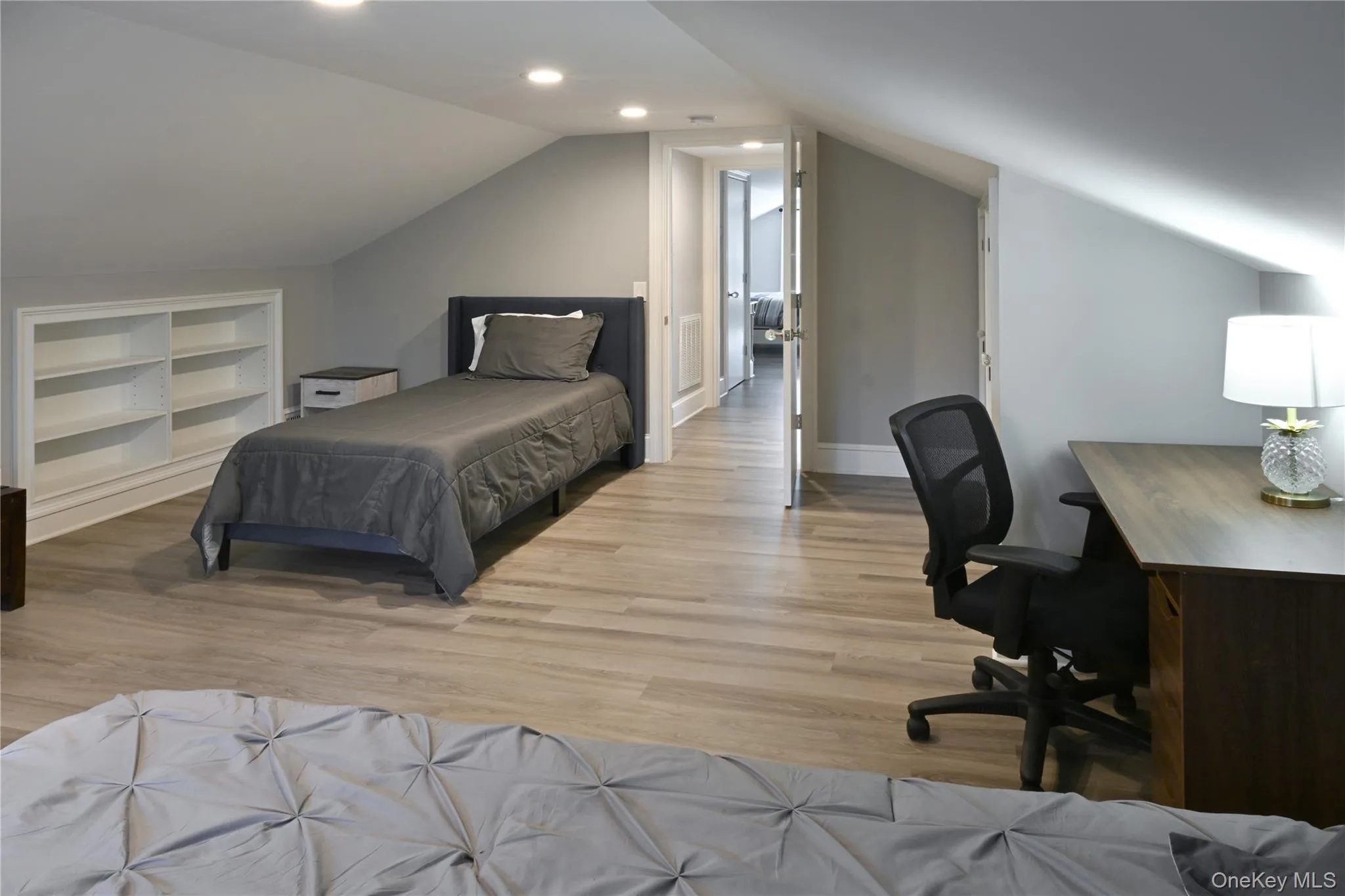 Bedroom with light wood-type flooring, lofted ceiling, a desk, and recessed lighting Bedroom with light wood-type flooring, lofted ceiling, a desk, and recessed lighting