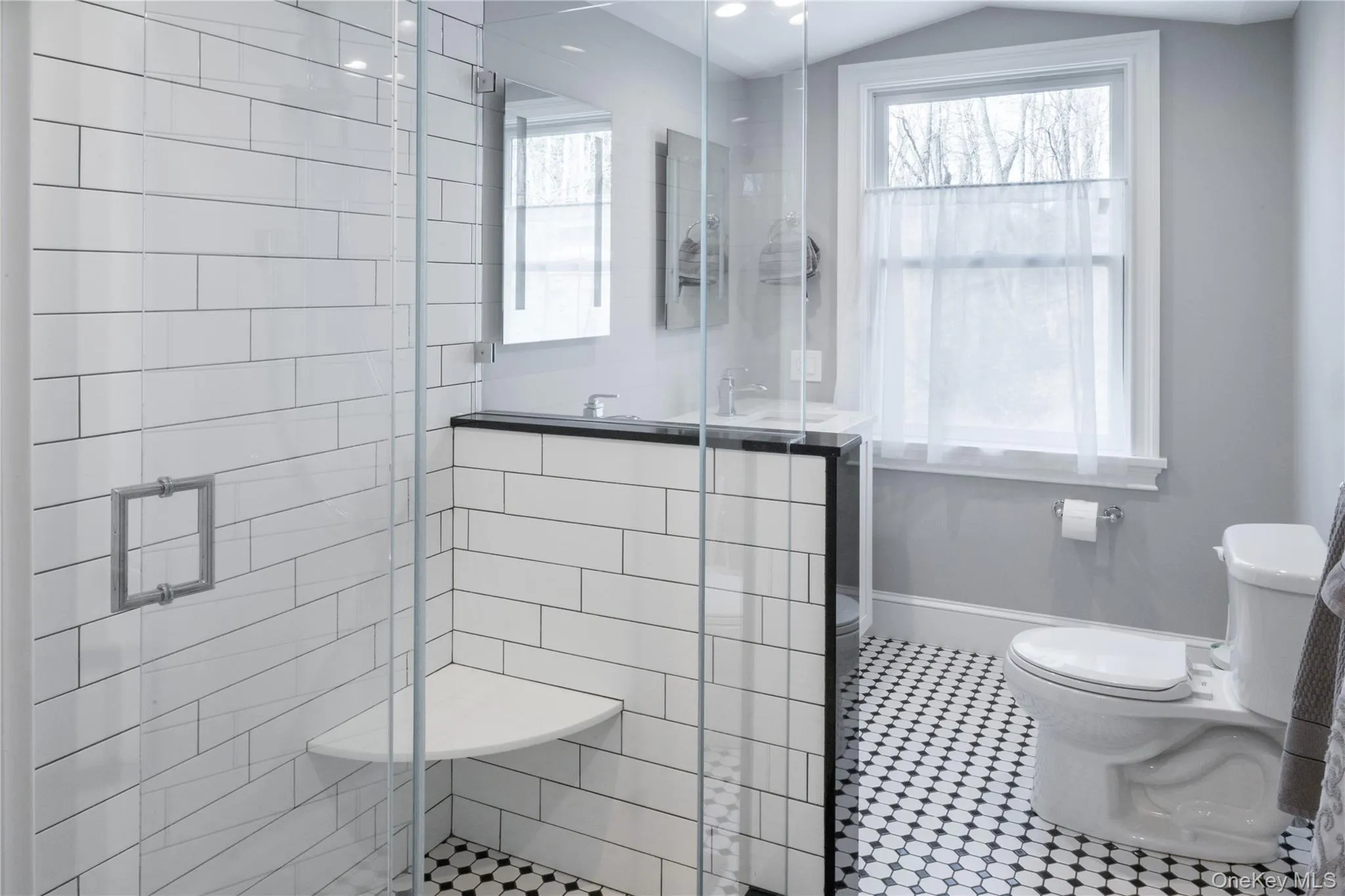 Full bathroom featuring toilet and a stall shower Full bathroom featuring toilet and a stall shower