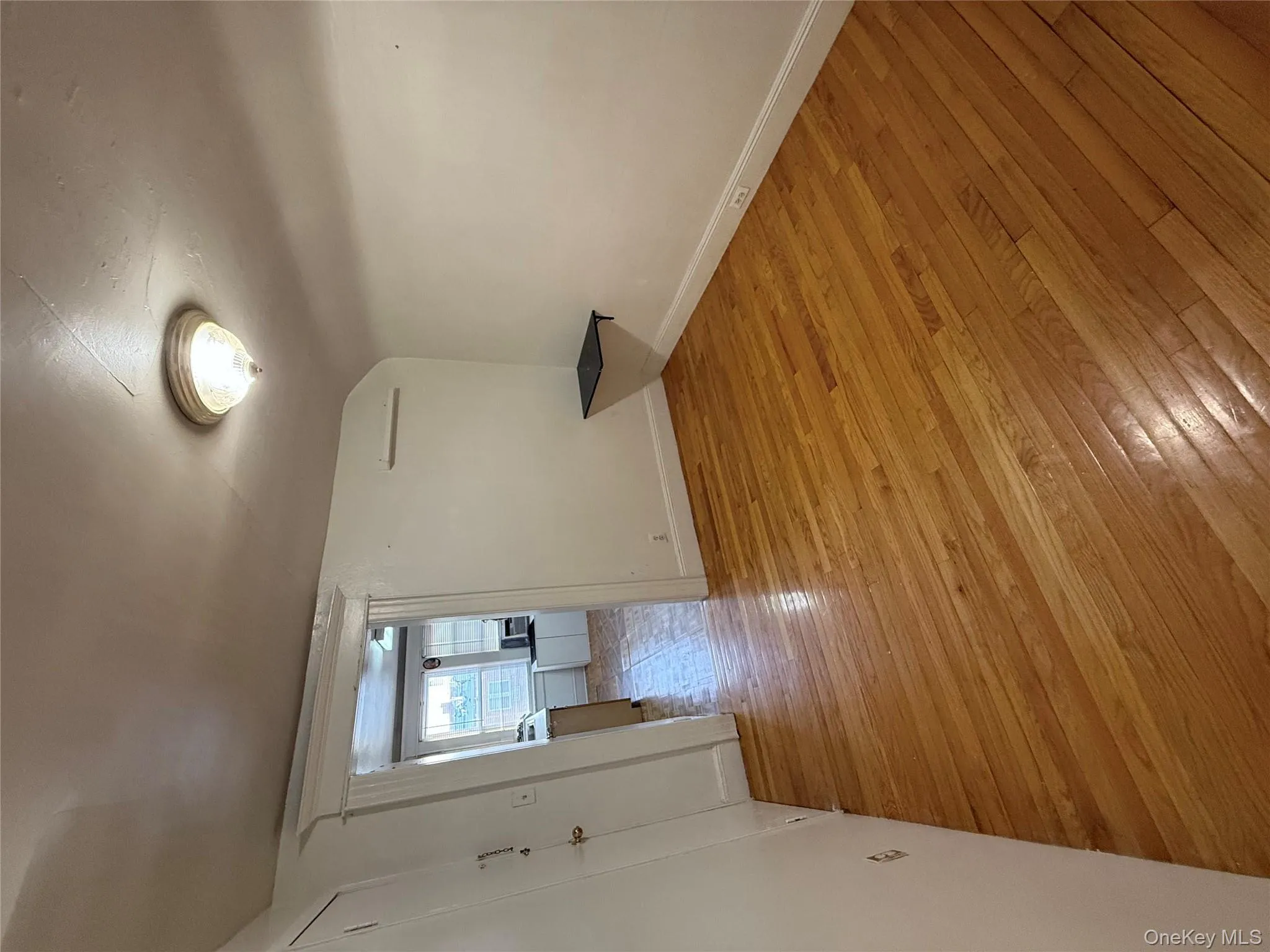 Empty room with light wood-style flooring and vaulted ceiling Empty room with light wood-style flooring and vaulted ceiling