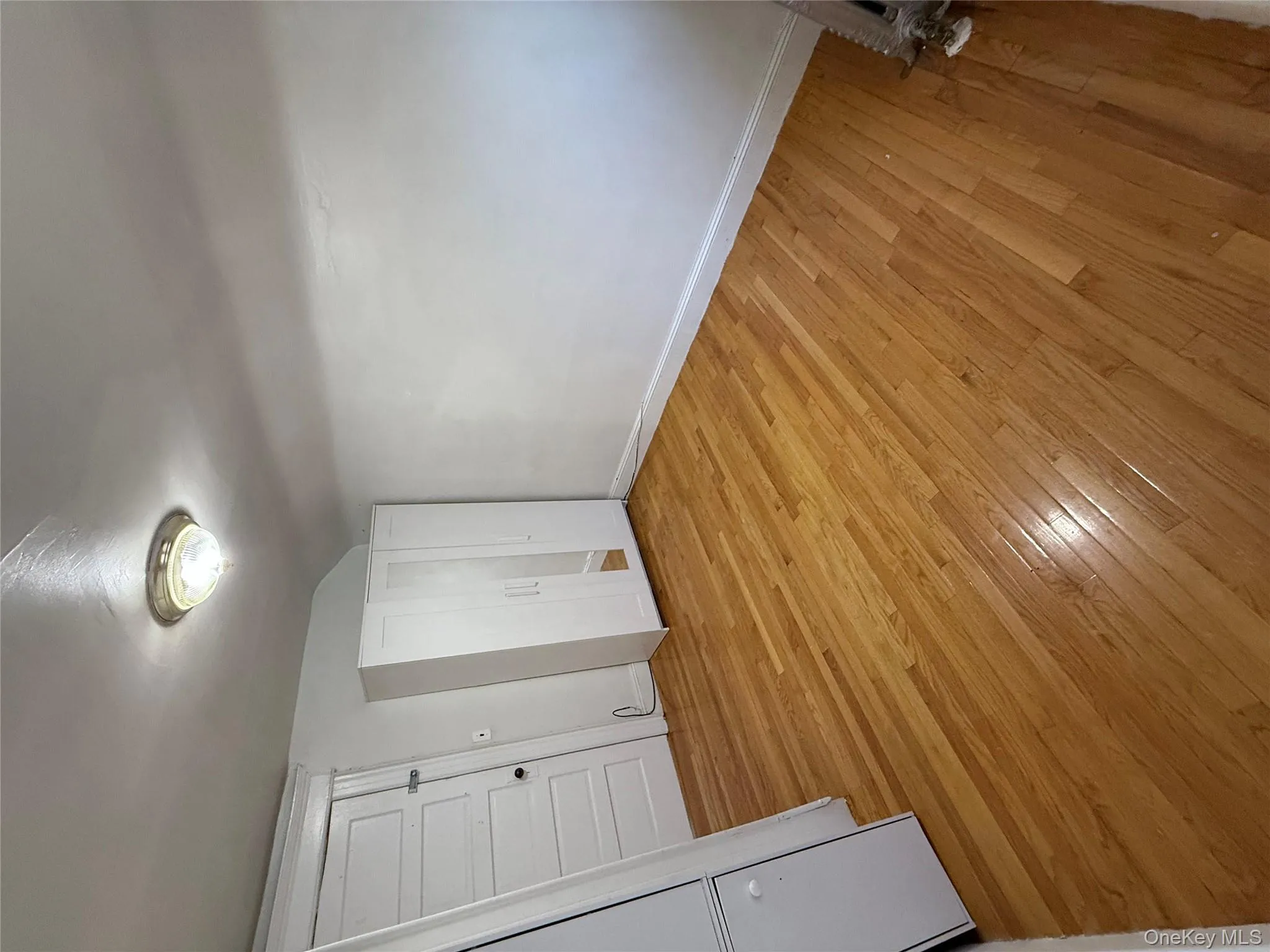 Unfurnished bedroom with light wood finished floors and vaulted ceiling Unfurnished bedroom with light wood finished floors and vaulted ceiling