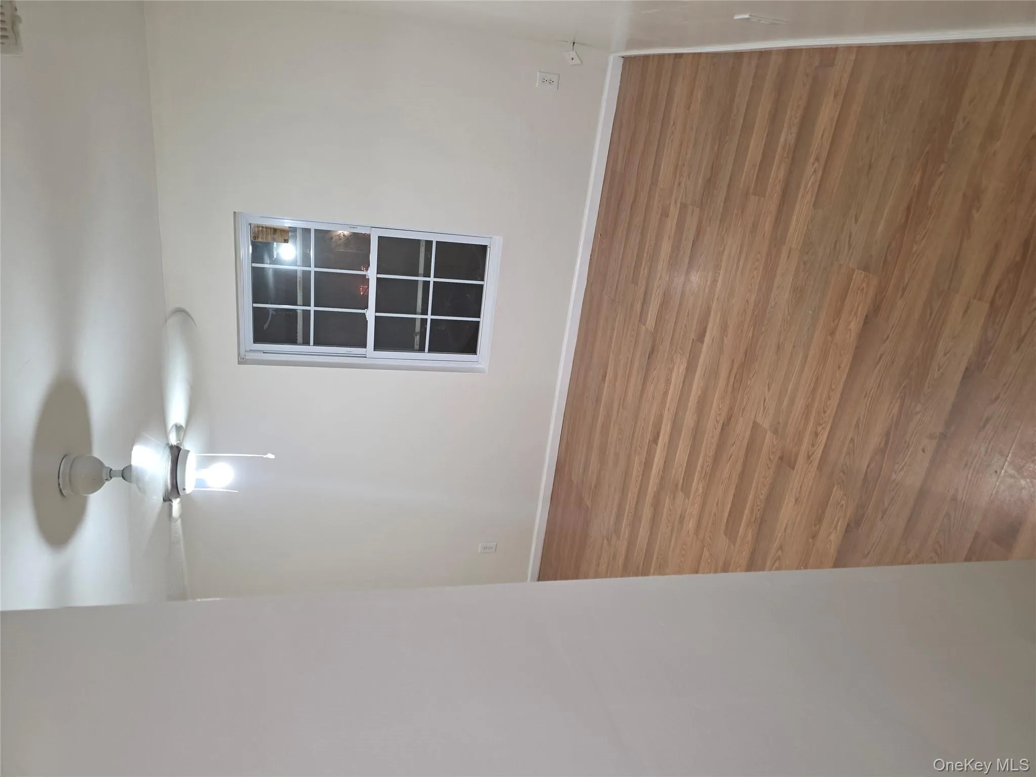 Empty room featuring wood finished floors and ceiling fan Empty room featuring wood finished floors and ceiling fan