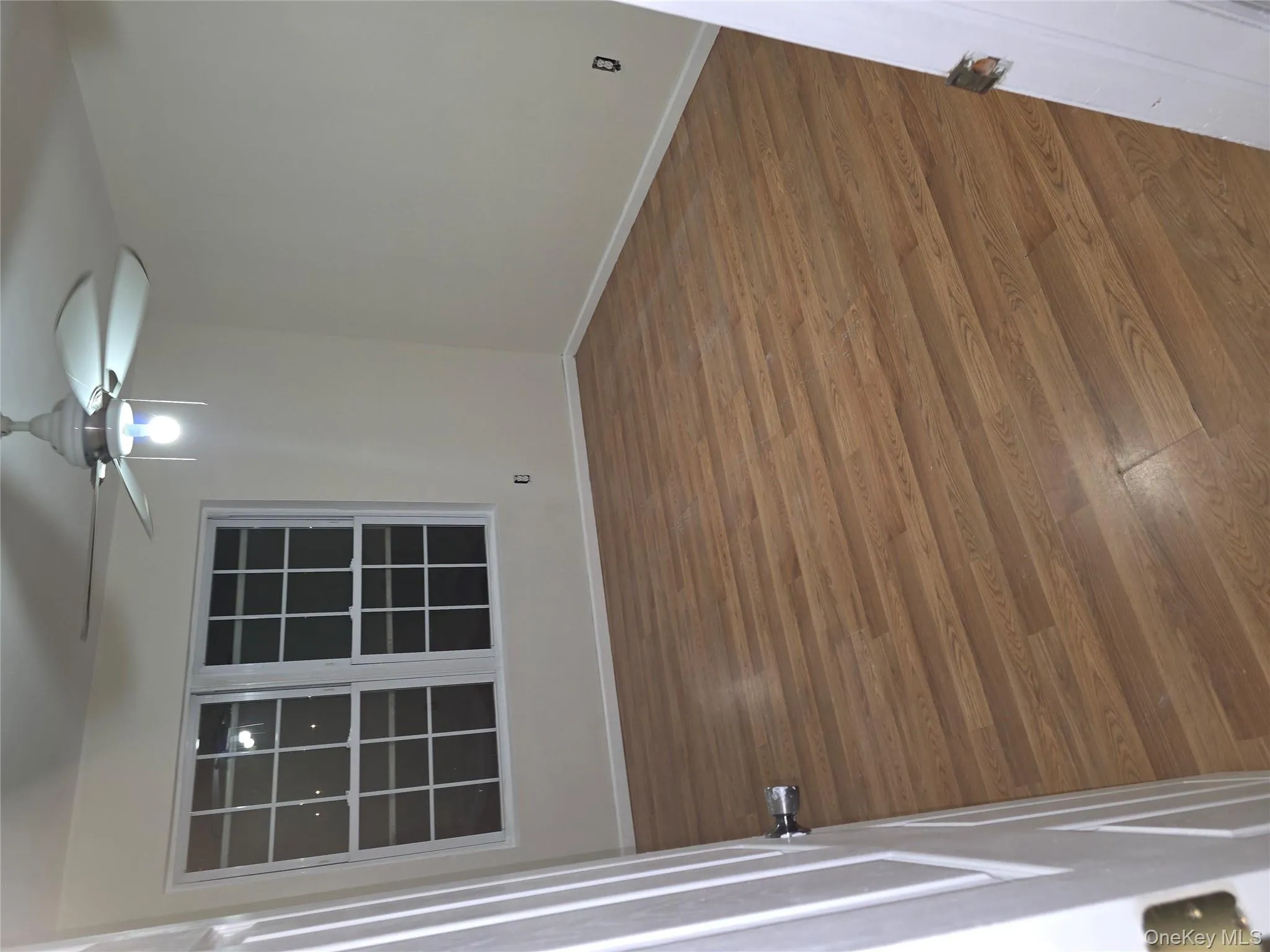 Unfurnished room featuring light wood-type flooring and ceiling fan Unfurnished room featuring light wood-type flooring and ceiling fan