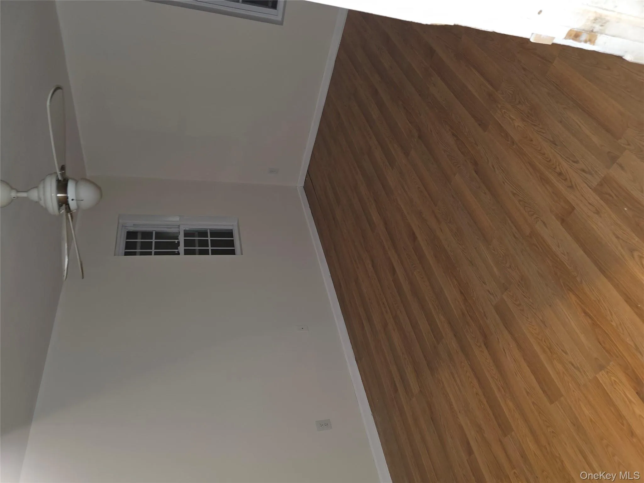 Unfurnished room featuring wood finished floors and ceiling fan Unfurnished room featuring wood finished floors and ceiling fan