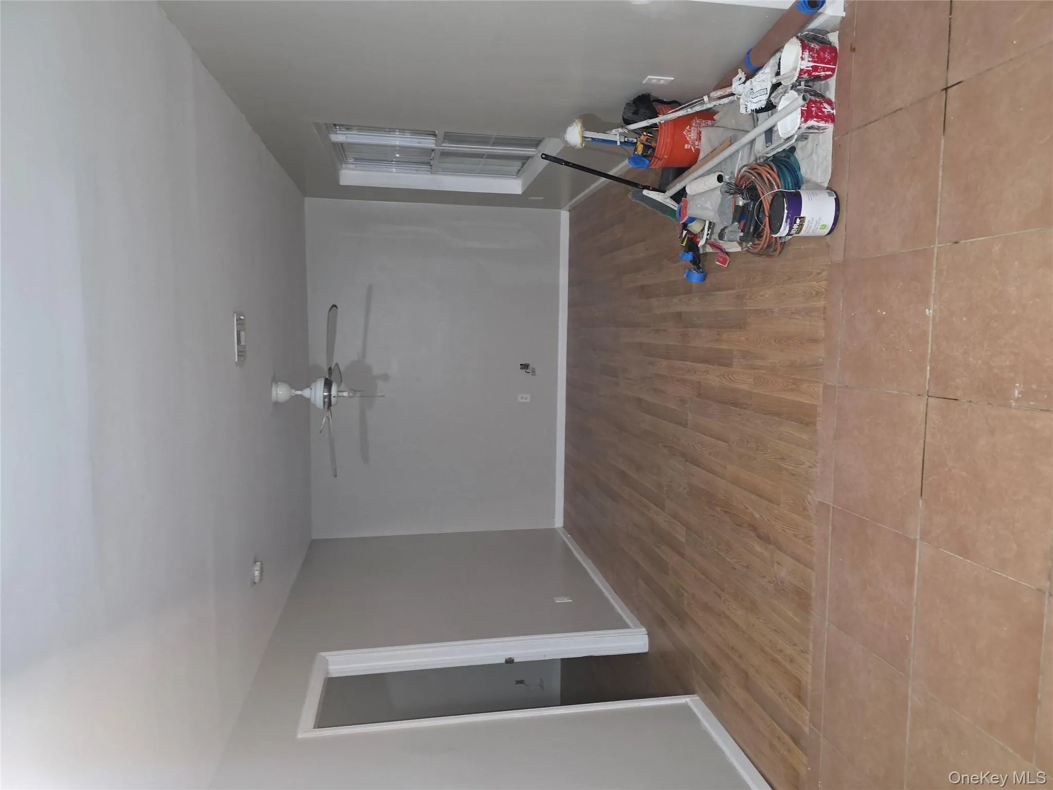 Empty room with light wood finished floors and ceiling fan Empty room with light wood finished floors and ceiling fan