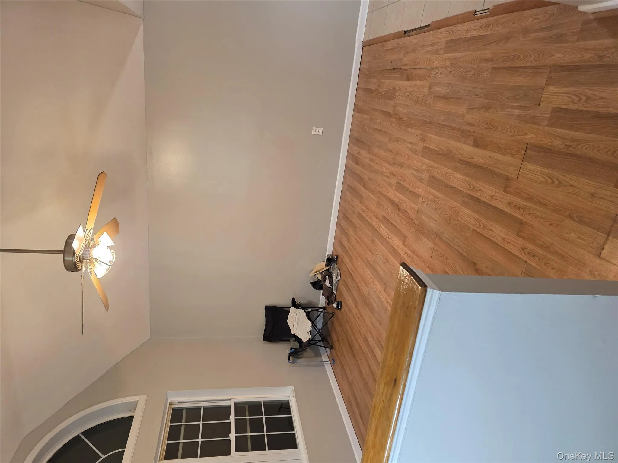 Spare room with lofted ceiling, light wood-style floors, and ceiling fan Spare room with lofted ceiling, light wood-style floors, and ceiling fan