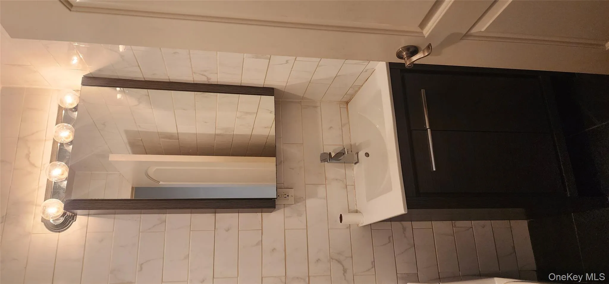 Bathroom featuring vanity and tile walls Bathroom featuring vanity and tile walls
