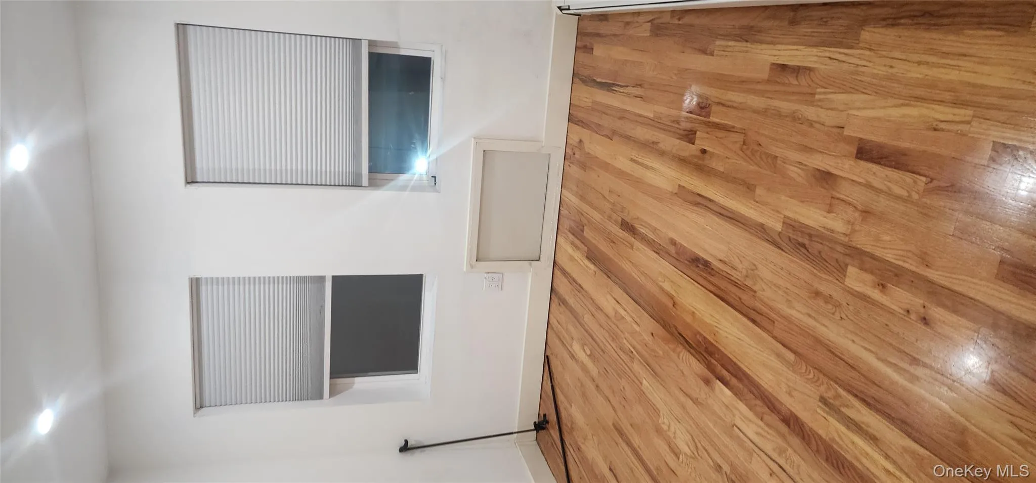 Empty room with light wood-style flooring and baseboards Empty room with light wood-style flooring and baseboards