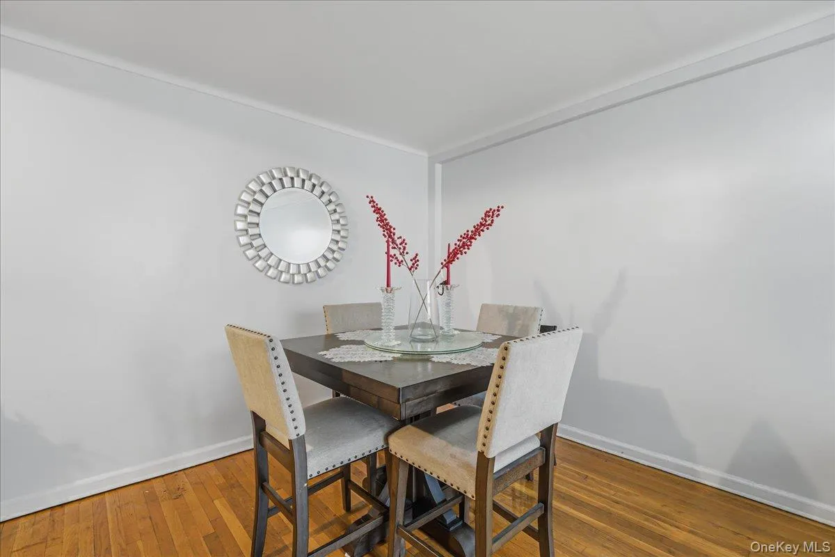 Dining space with wood-type flooring and baseboards Dining space with wood-type flooring and baseboards