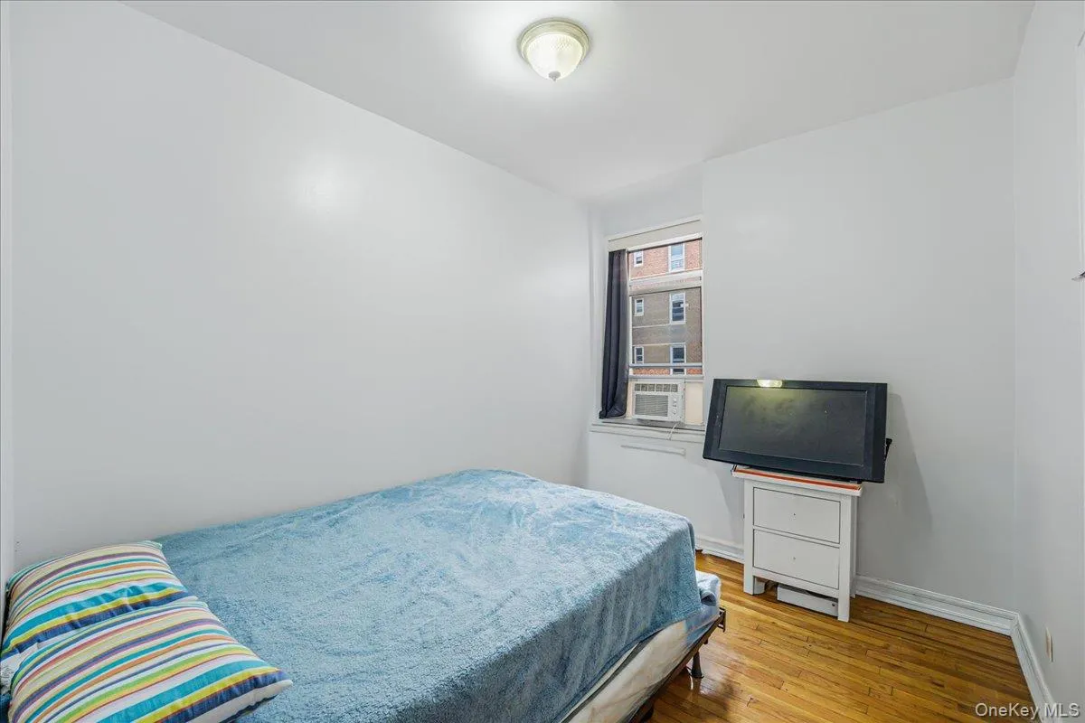 Bedroom featuring hardwood / wood-style floors and baseboards Bedroom featuring hardwood / wood-style floors and baseboards