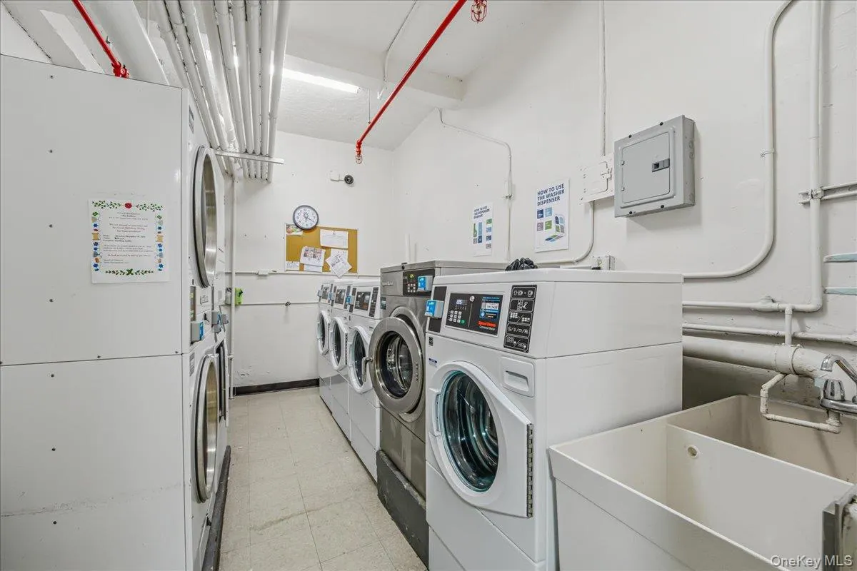 Shared laundry featuring electric panel, separate washer and dryer, and heating unit Shared laundry featuring electric panel, separate washer and dryer, and heating unit