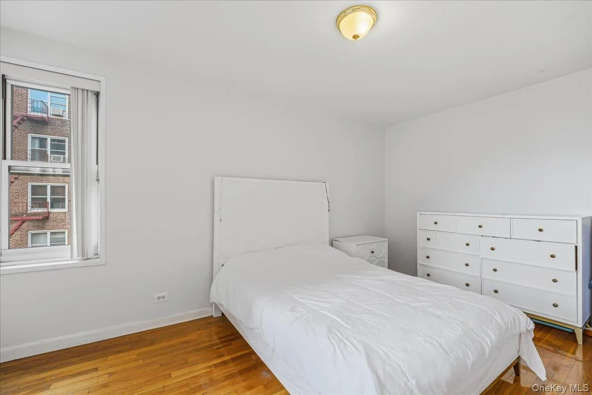 Bedroom with light wood-style flooring and baseboards Bedroom with light wood-style flooring and baseboards