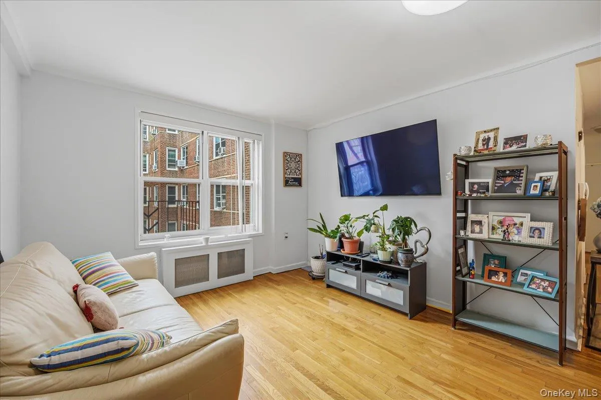 Living area featuring radiator heating unit and light wood-style flooring Living area featuring radiator heating unit and light wood-style flooring