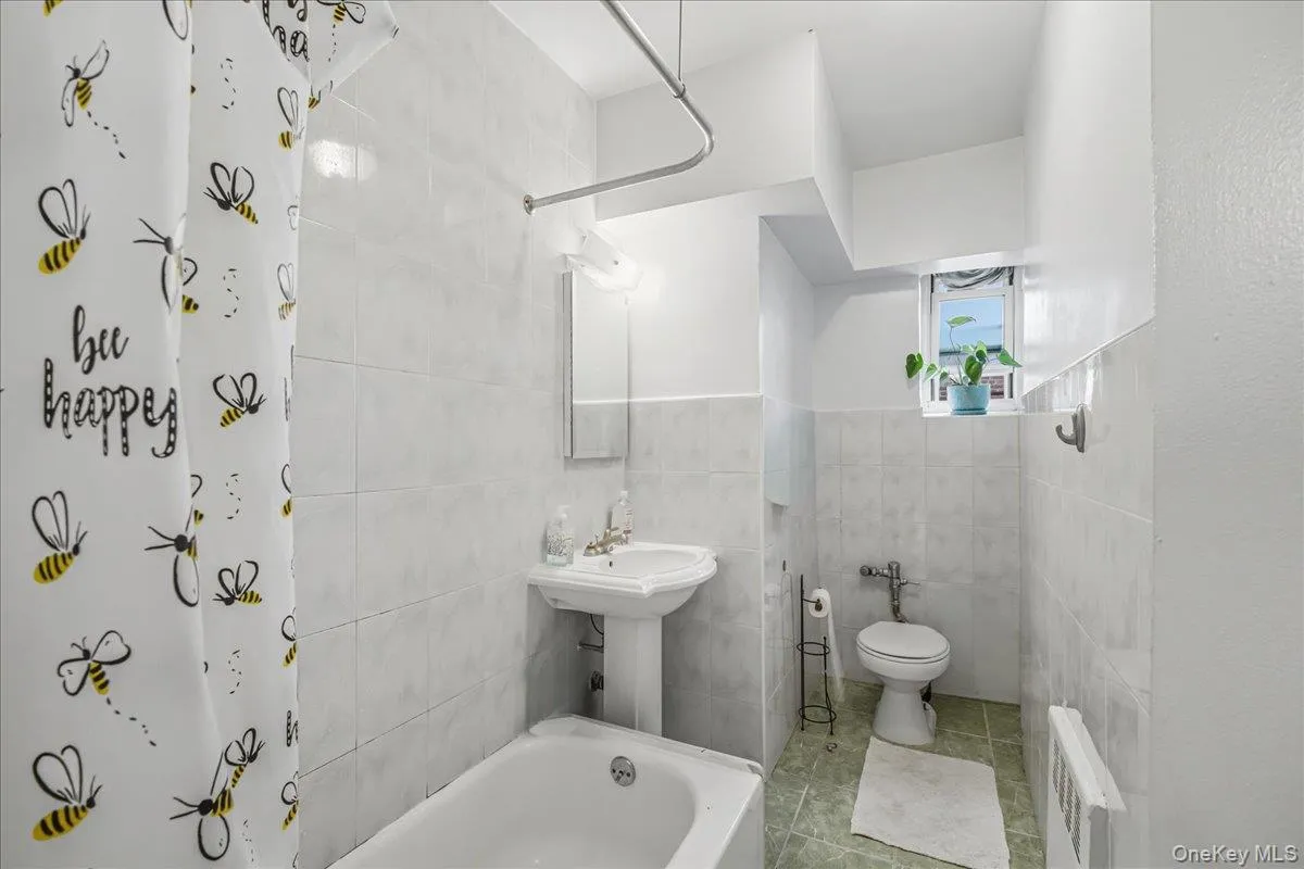 Bathroom with tile walls and tile patterned floors Bathroom with tile walls and tile patterned floors