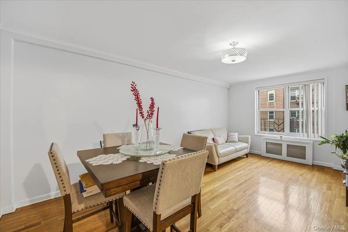 Dining room with hardwood / wood-style flooring and radiator Dining room with hardwood / wood-style flooring and radiator